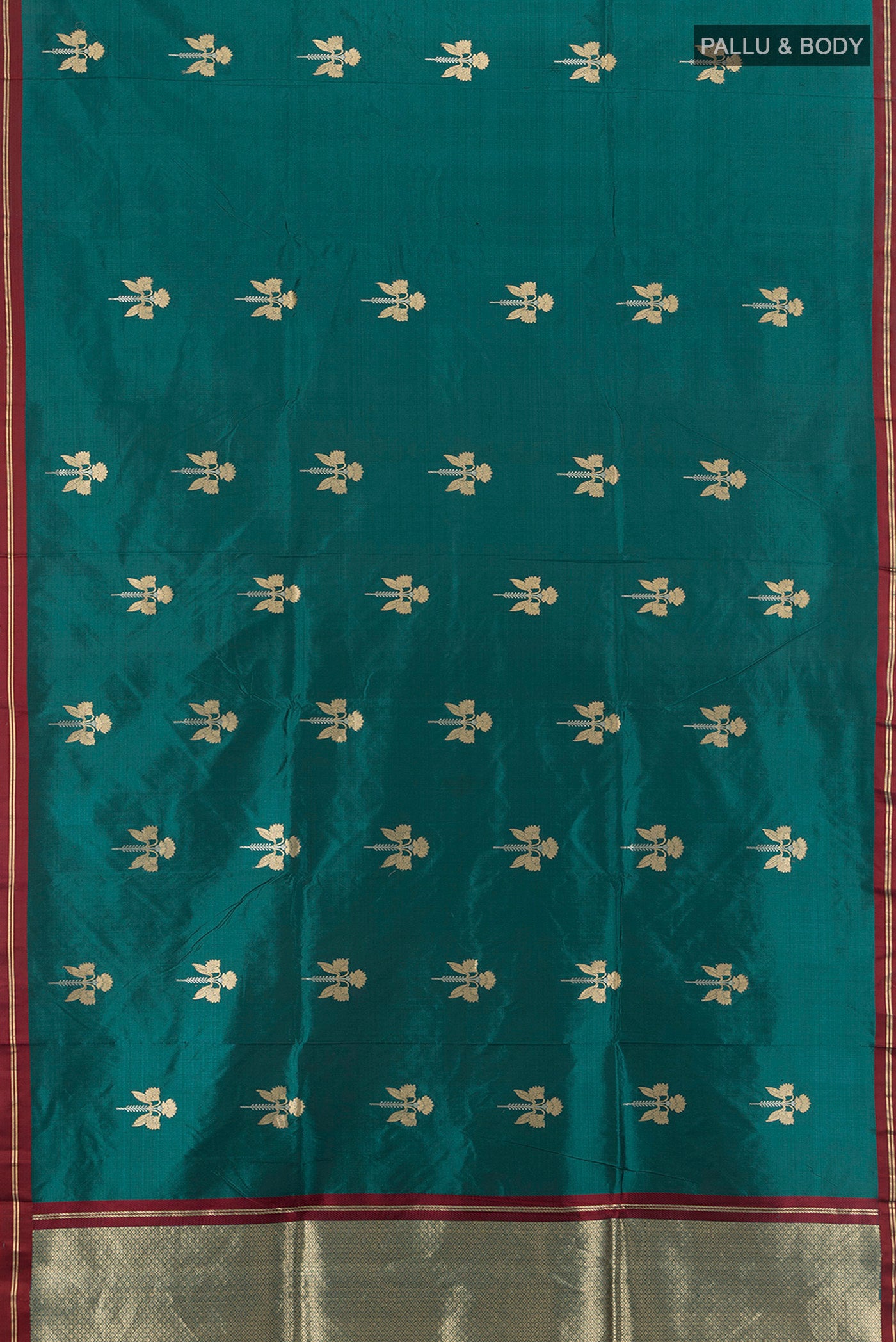 Flat view of Teal Banarasi Katan Silk Saree with Zari Butta on the body and Plain Border. 