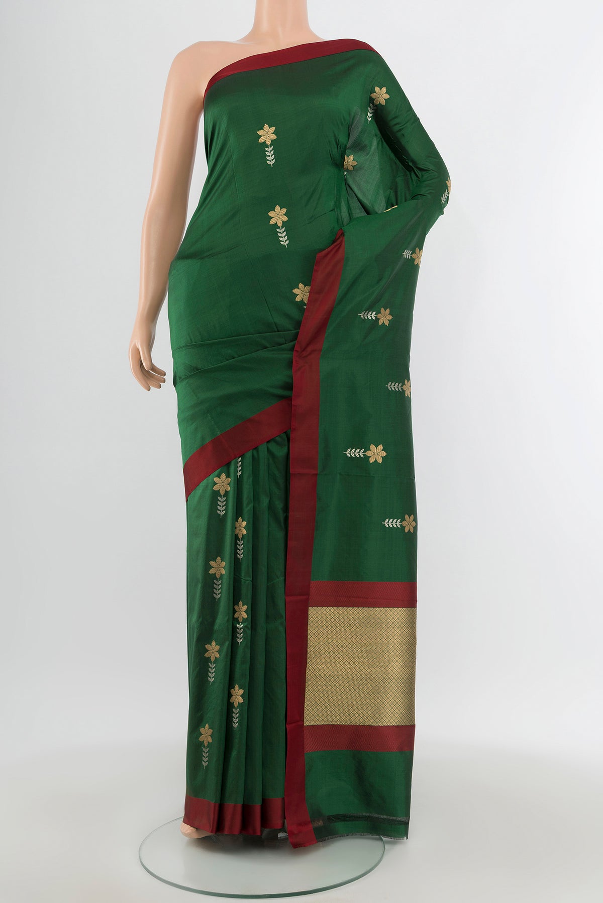 Bottle Green Banarasi Katan Silk Saree with Zari Butta on the body and Plain Border.  displayed on a mannequin