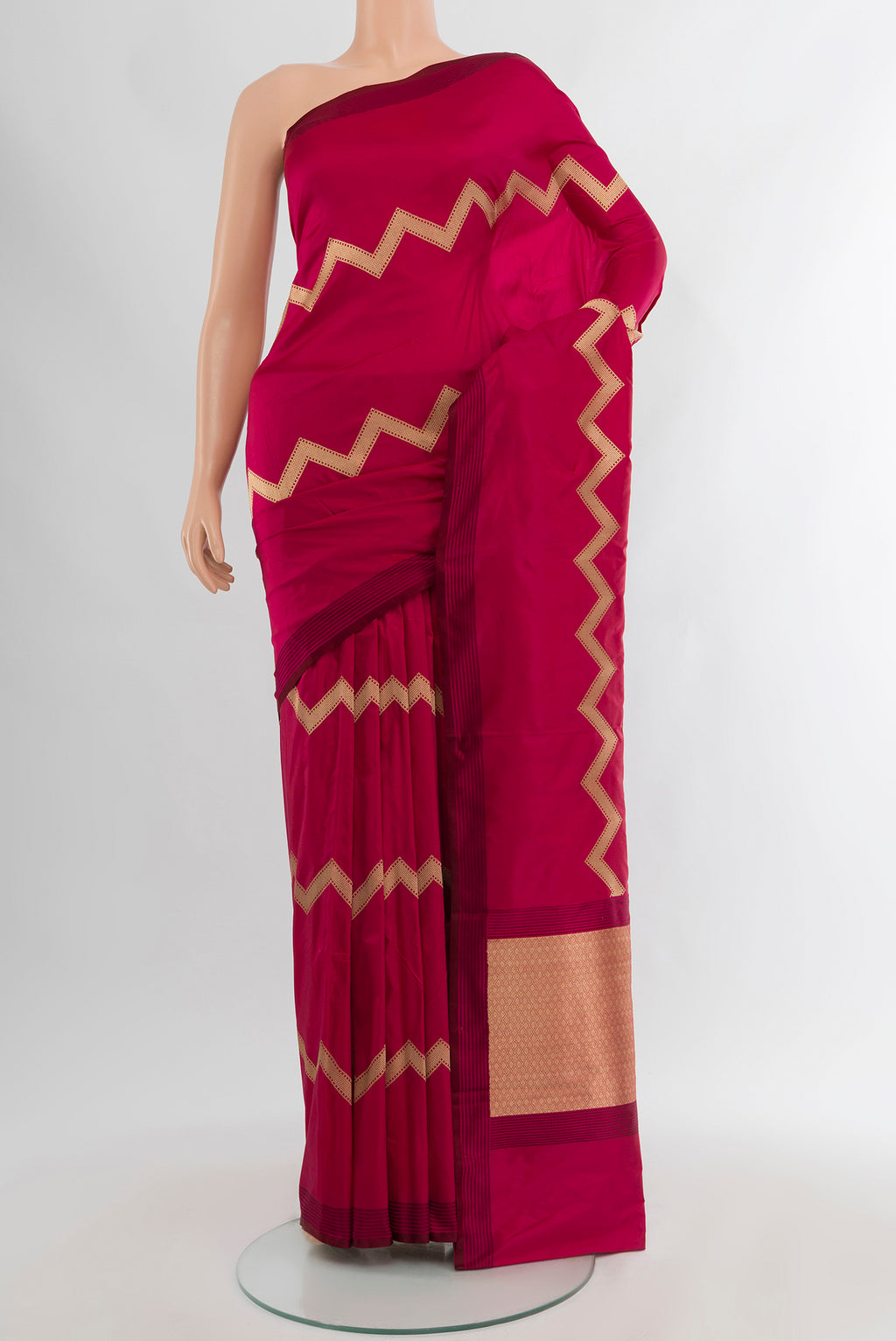 Maroon Banarasi Katan Silk Saree with Zig Zag design on the body and Thread Border.  displayed on a mannequin