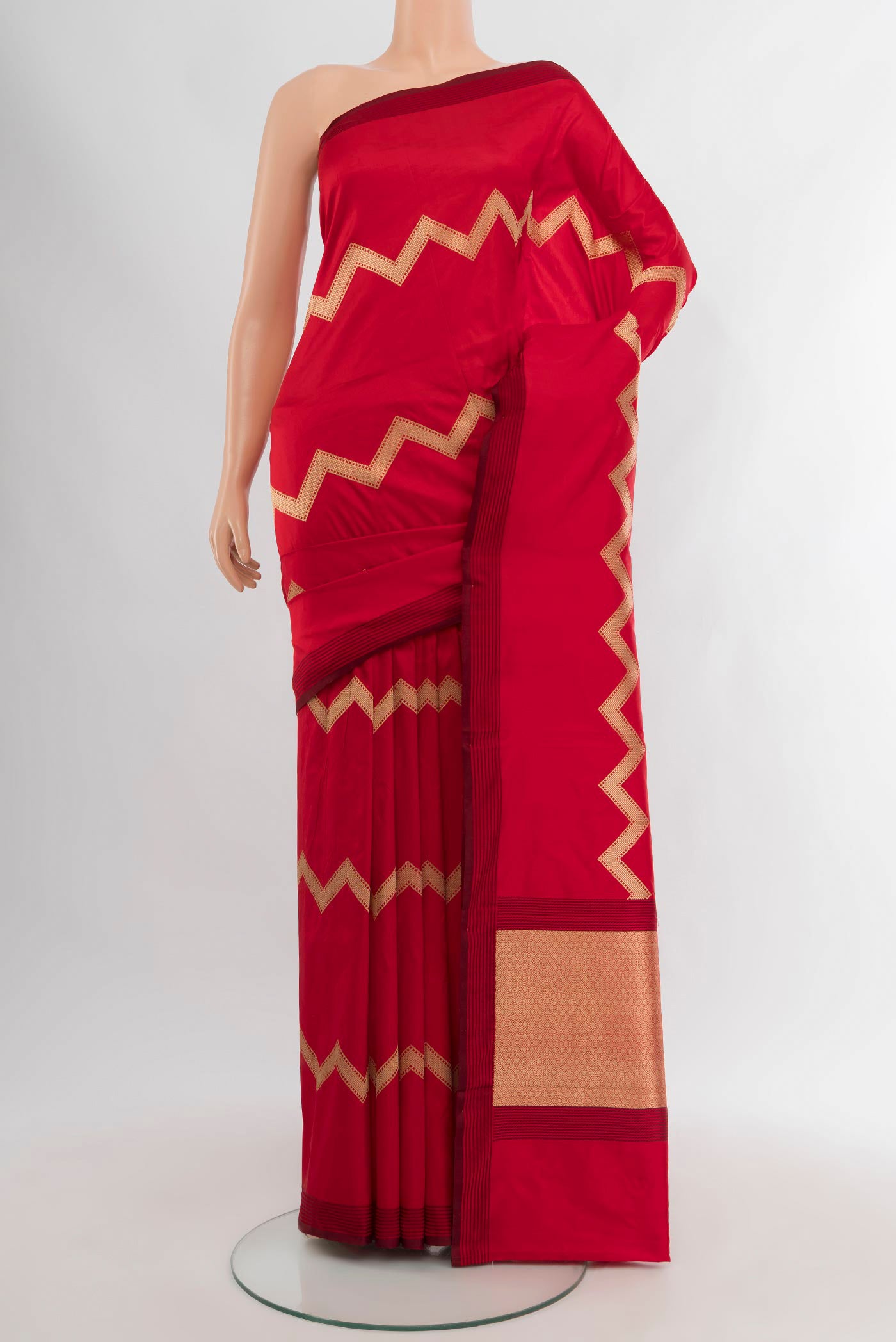 Red Banarasi Katan Silk Saree with Zig Zag design on the body and Plain Border.  displayed on a mannequin