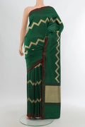 Bottle Green Banarasi Katan Silk Saree with Zig Zag design on the body and Plain Border.  displayed on a mannequin