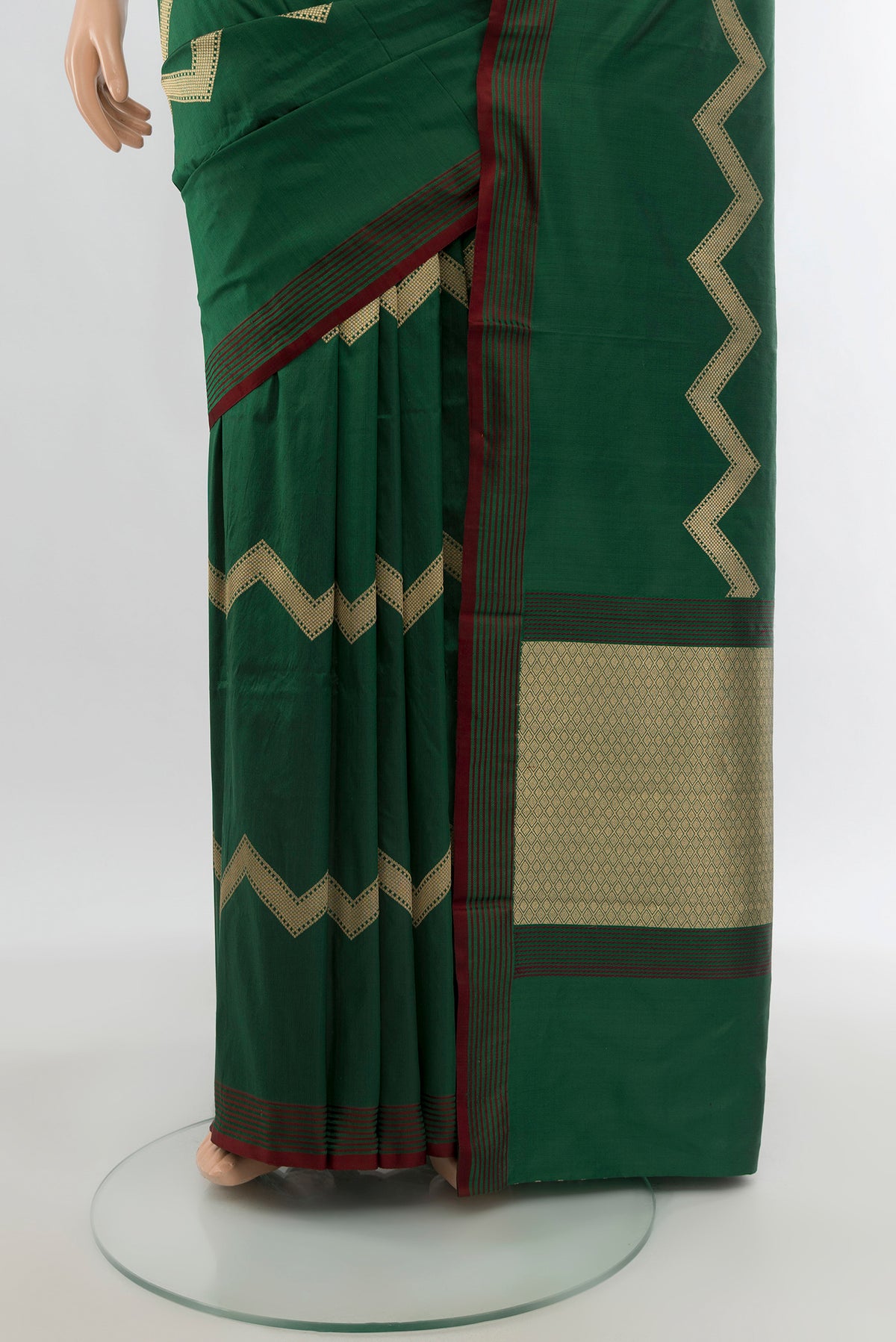 Pleats and pallu of Bottle Green Banarasi Katan Silk Saree with Zig Zag design on the body and Plain Border. 