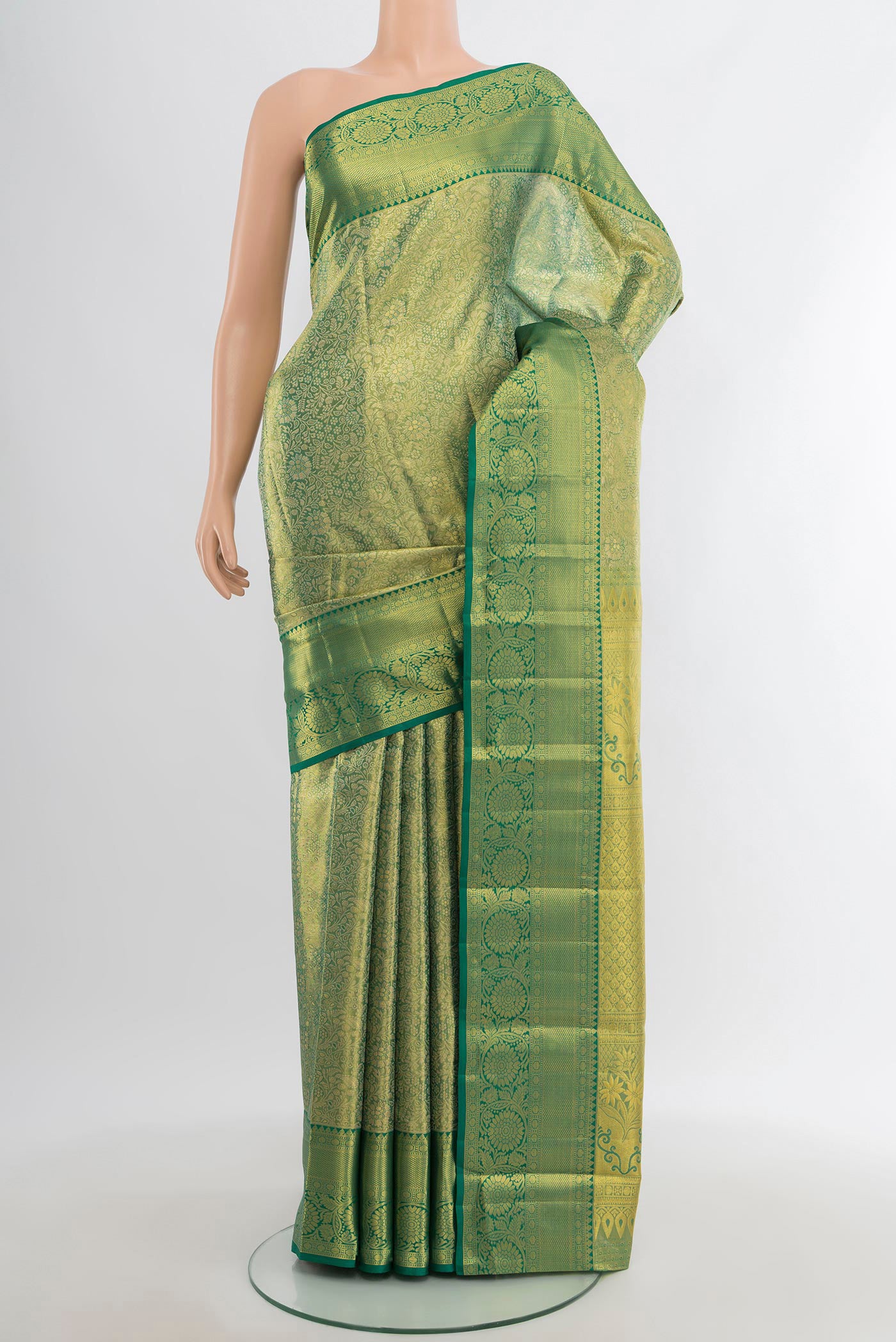 Light Green Kanchipuram Tissue Silk Saree with Zari Brocade on the body and Zari Border.  displayed on a mannequin