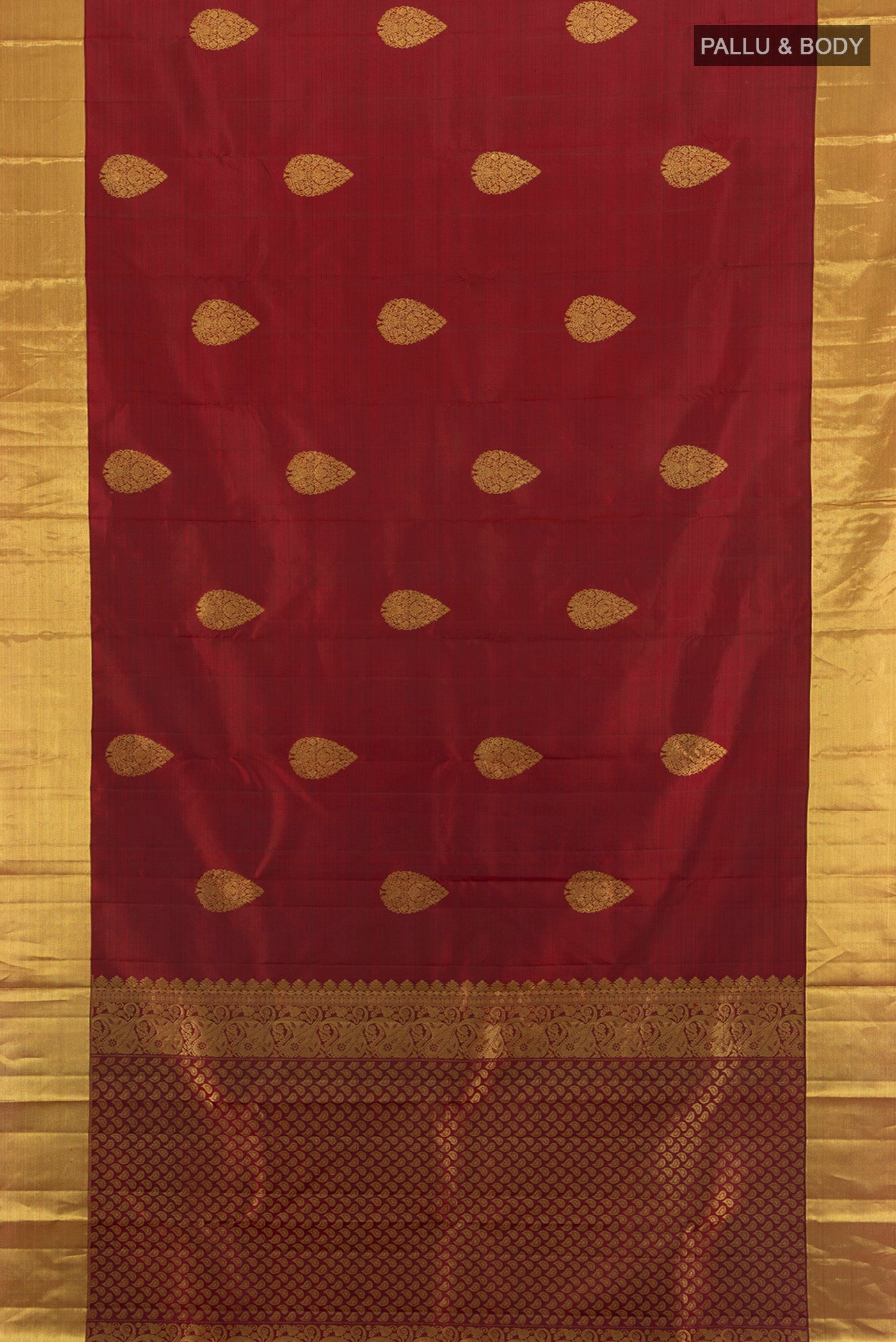 Flat view of Maroon Kanchipuram Silk Saree with Zari Butta on the body and Zari Border. 