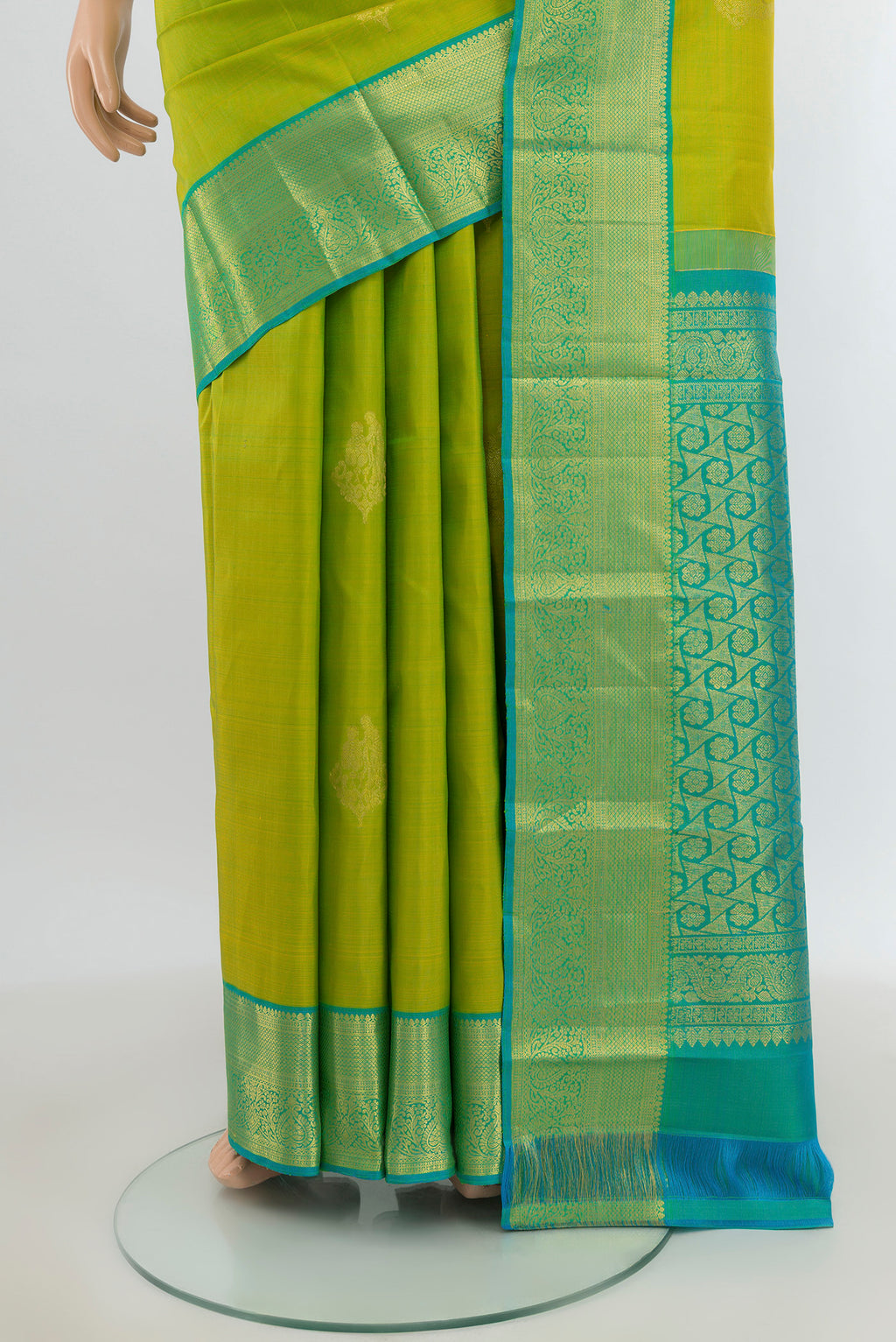 Pleats and pallu of Parrot Green Kanchipuram Silk Saree with Zari Butta on the body and Silk Border. 