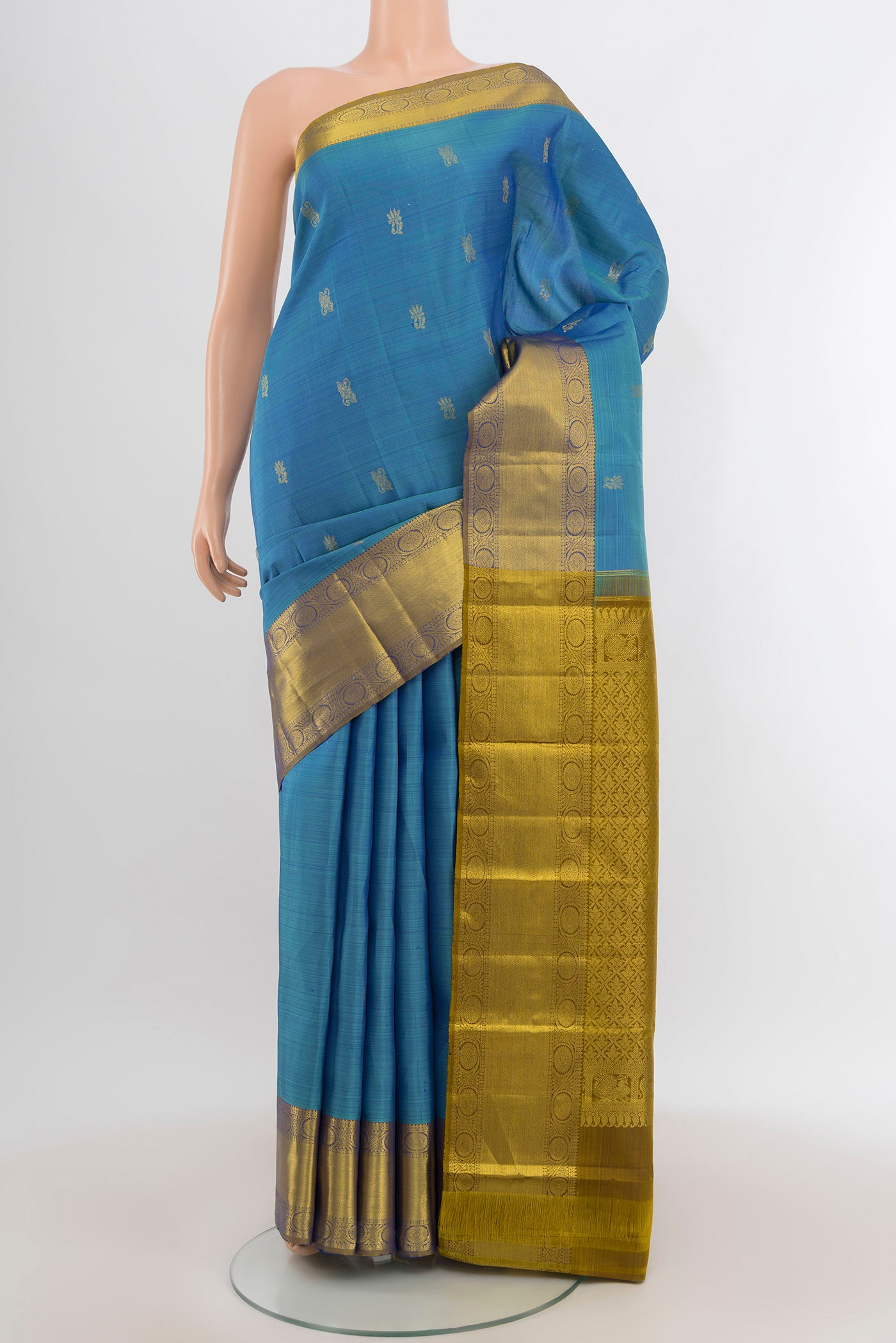Light Blue Kanchipuram Silk Saree with Zari Butta on the body and Zari Border.  displayed on a mannequin
