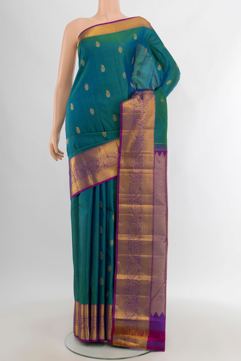 Peacock Blue Kanchipuram Silk Saree with Zari Butta on the body and Zari Border.  displayed on a mannequin