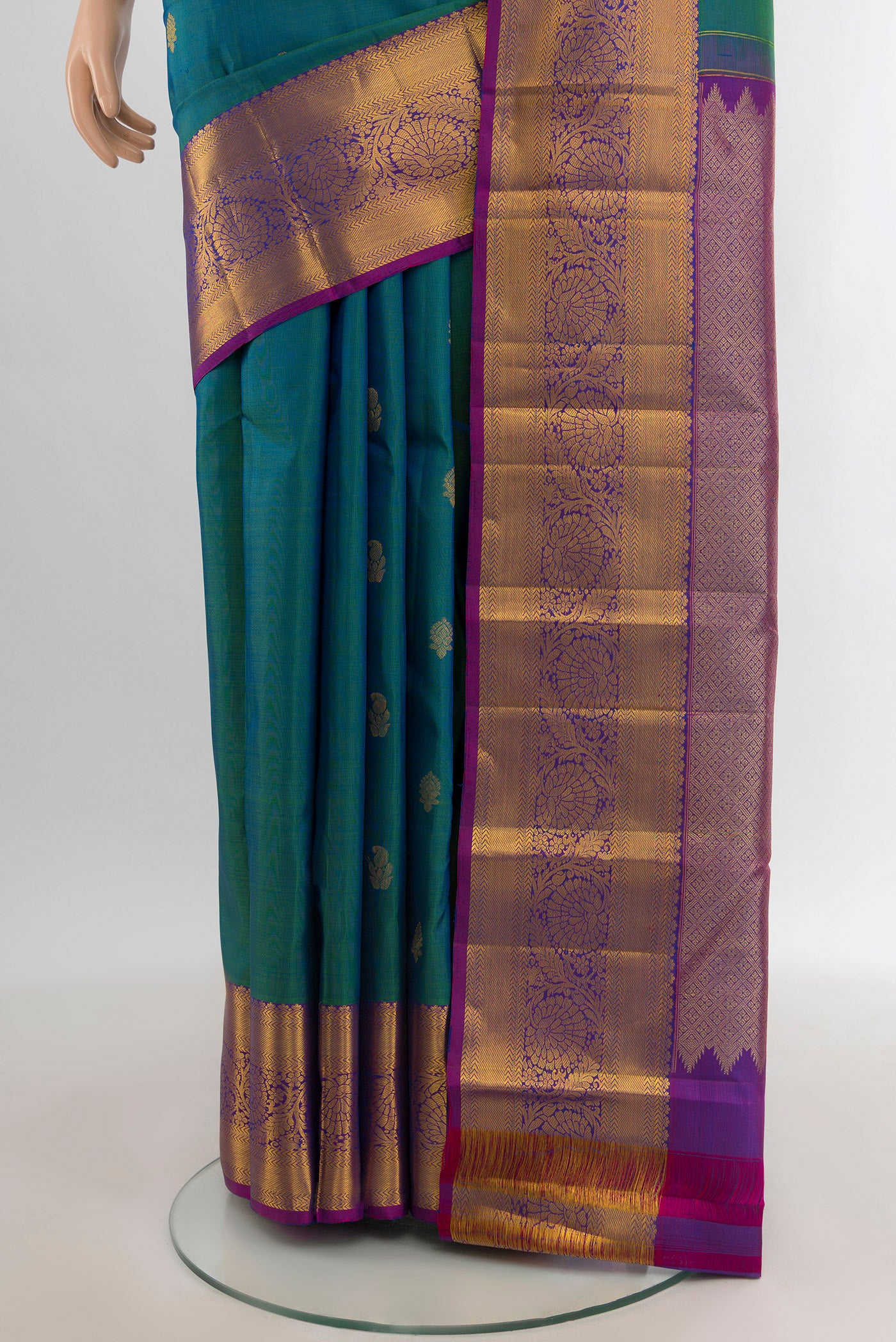 Pleats and pallu of Peacock Blue Kanchipuram Silk Saree with Zari Butta on the body and Zari Border. 