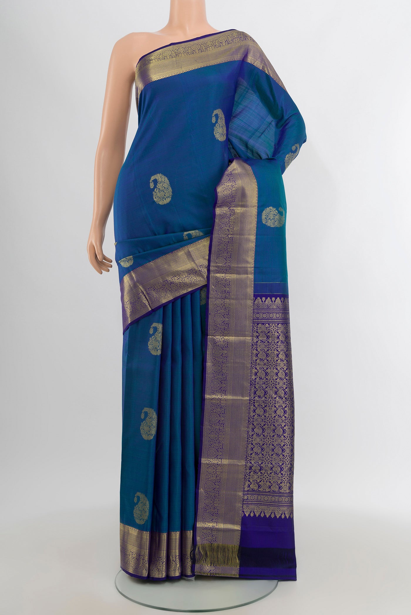 Peacock Blue Kanchipuram Silk Saree with Zari Butta on the body and Zari Border.  displayed on a mannequin