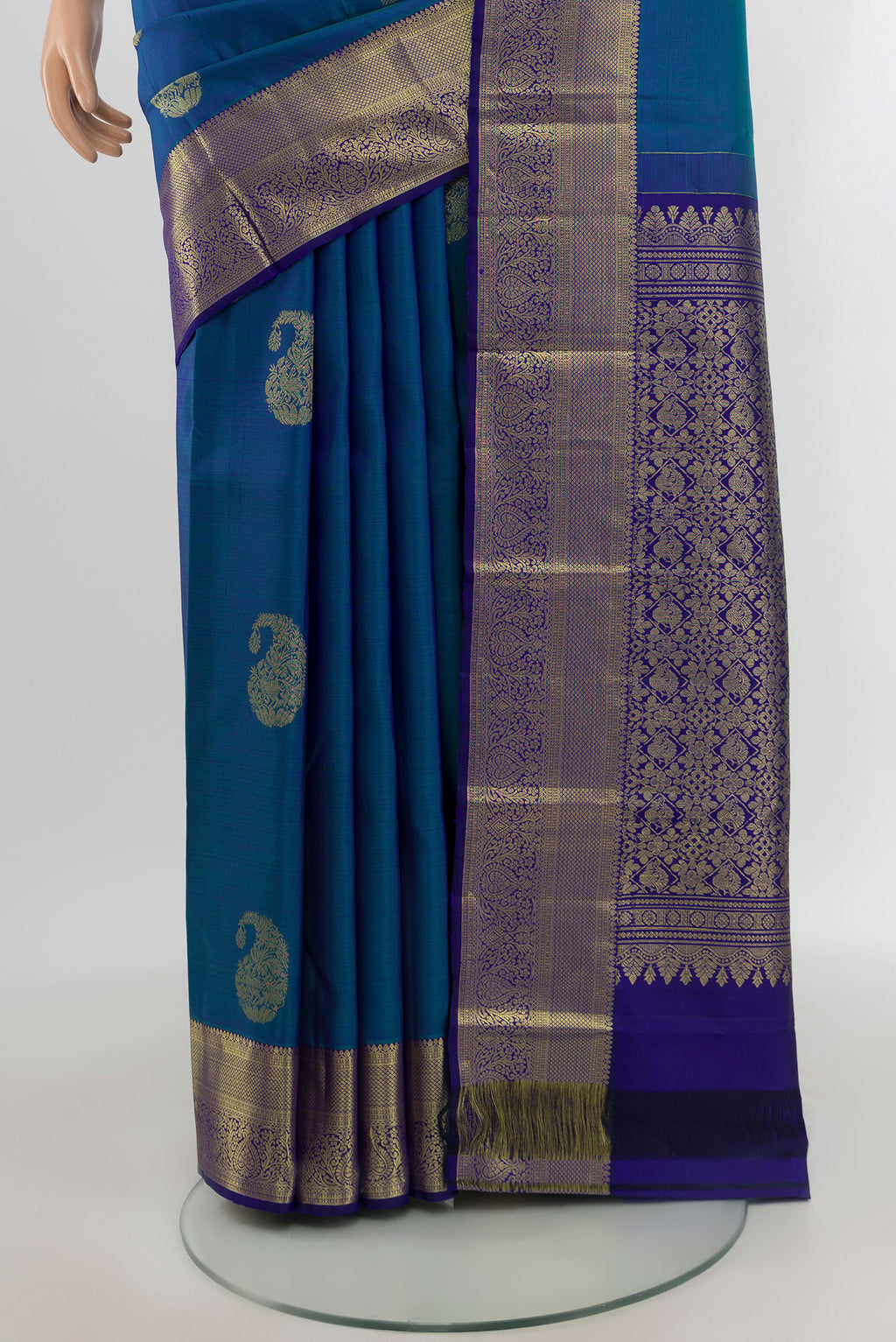 Pleats and pallu of Peacock Blue Kanchipuram Silk Saree with Zari Butta on the body and Zari Border. 
