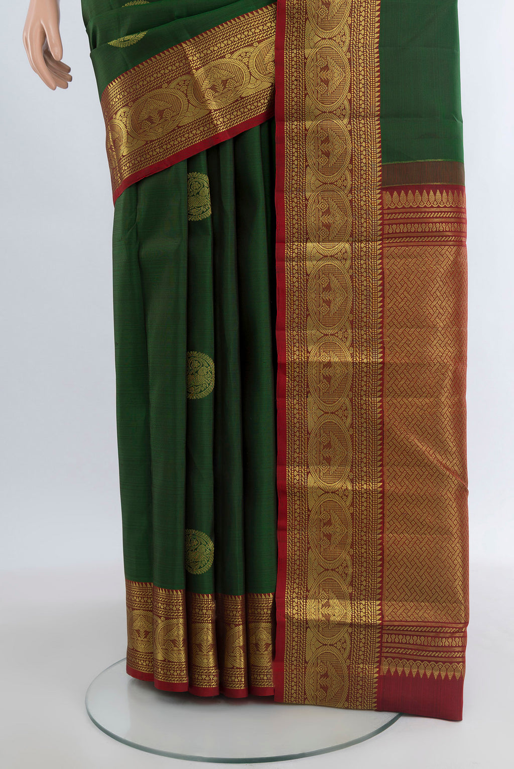 Pleats and pallu of Bottle Green Kanchipuram Silk Saree with Zari Butta on the body and Zari Border. 