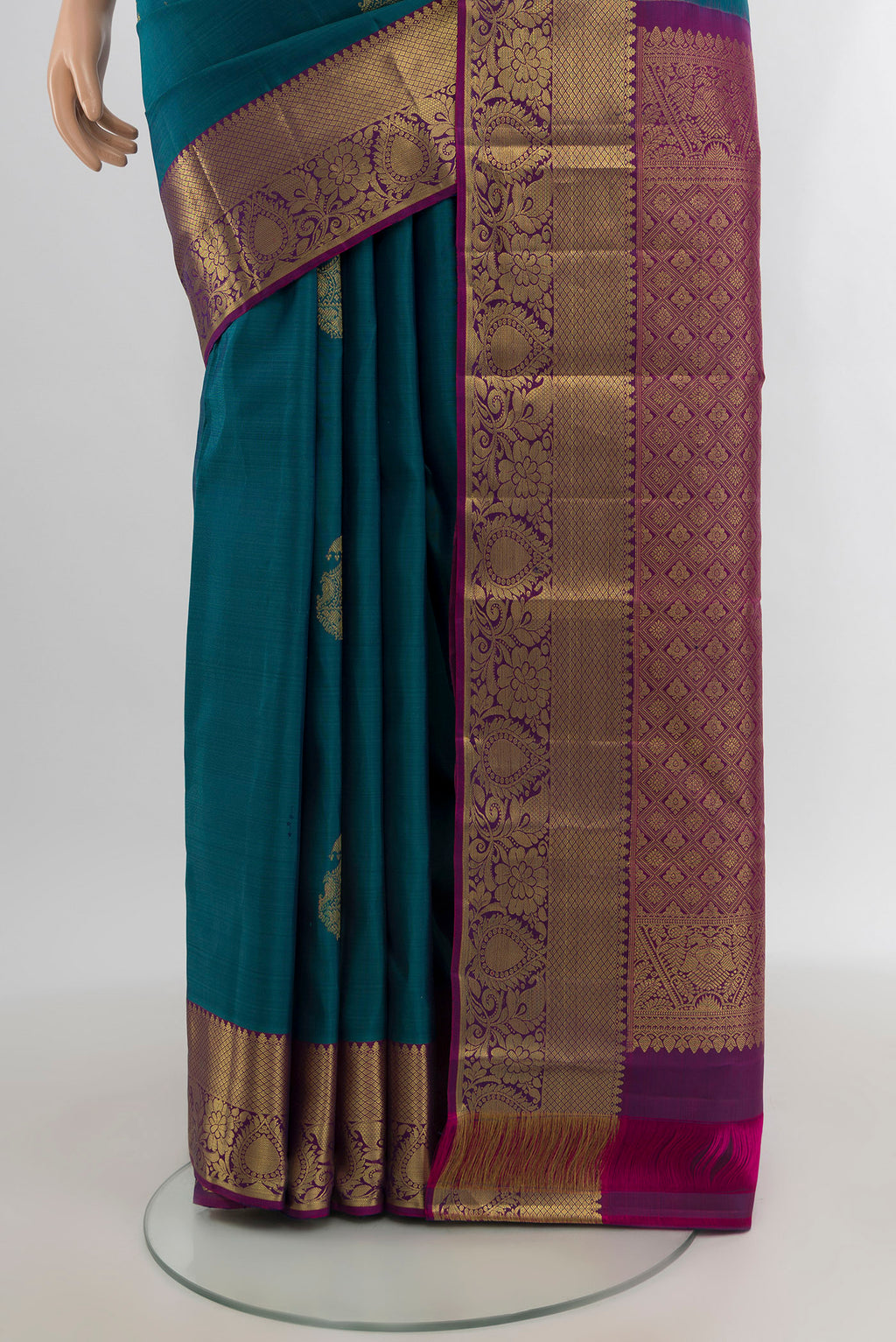 Pleats and pallu of Peacock Blue Kanchipuram Silk Saree with Zari Butta on the body and Zari Border. 