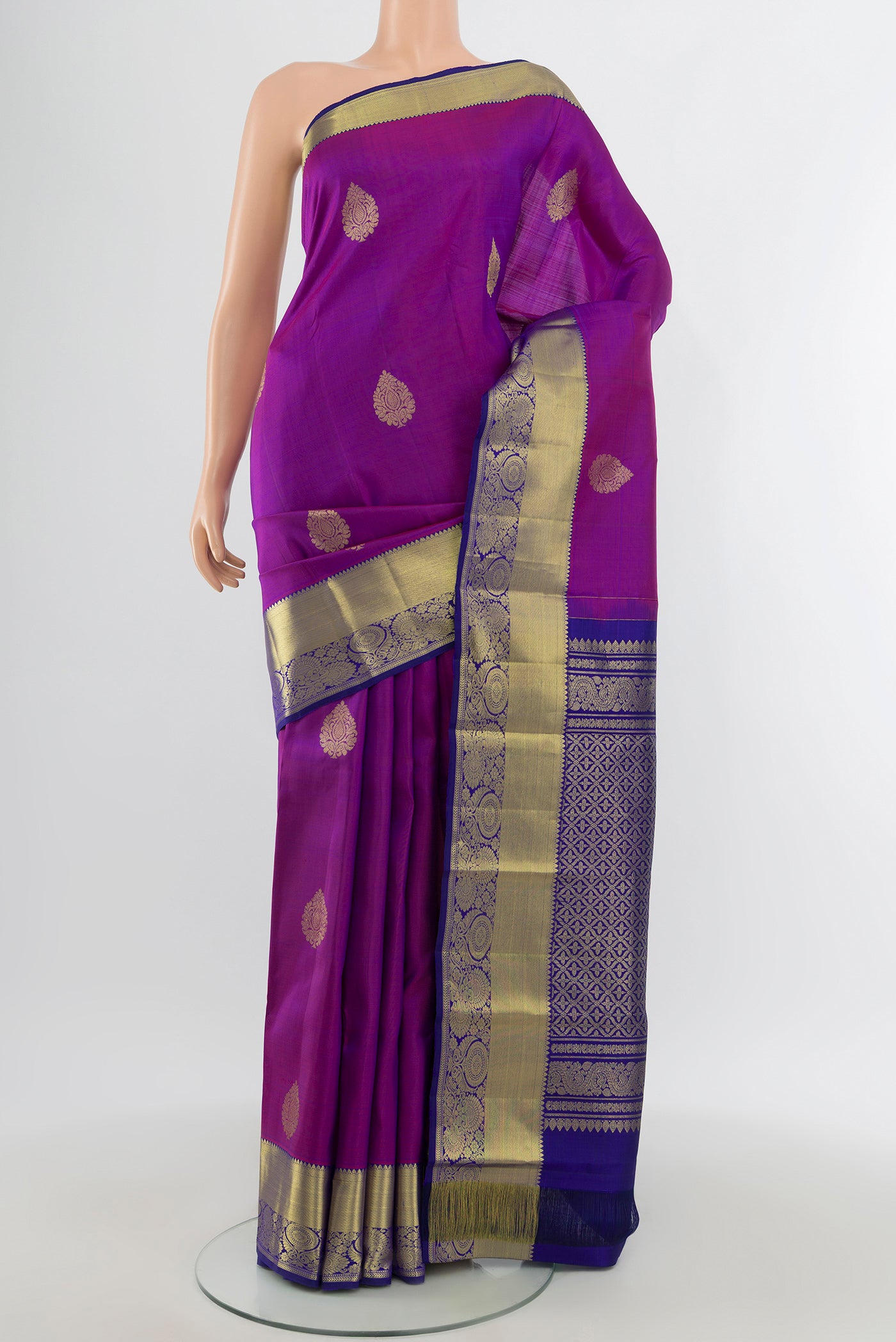 Purple Kanchipuram Silk Saree with Zari Butta on the body and Zari Border.  displayed on a mannequin