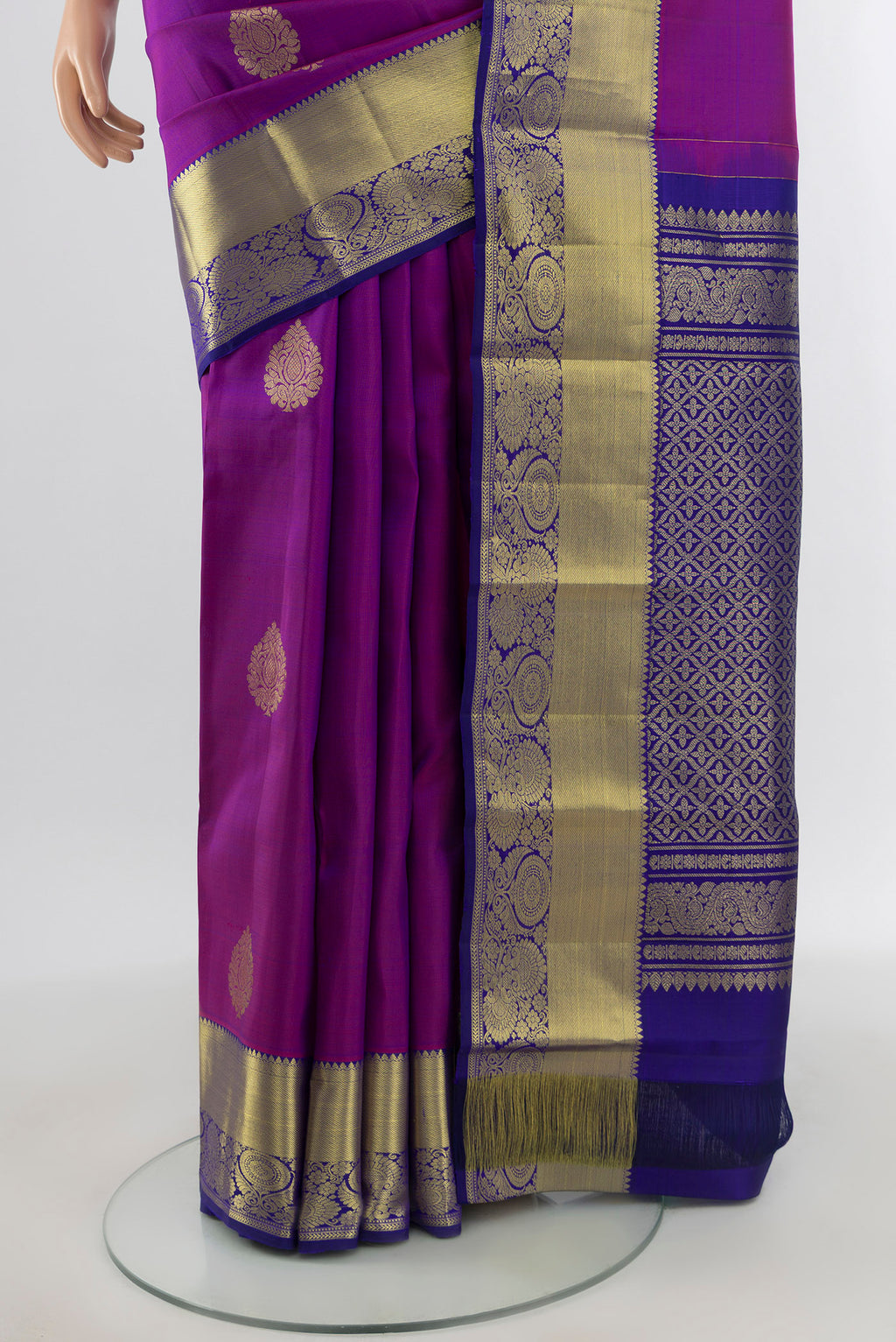 Pleats and pallu of Purple Kanchipuram Silk Saree with Zari Butta on the body and Zari Border. 