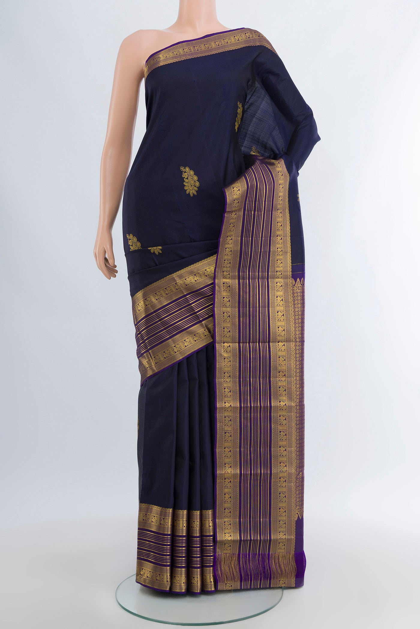 Navy Blue Kanchipuram Silk Saree with Zari Butta on the body and Zari Border.  displayed on a mannequin
