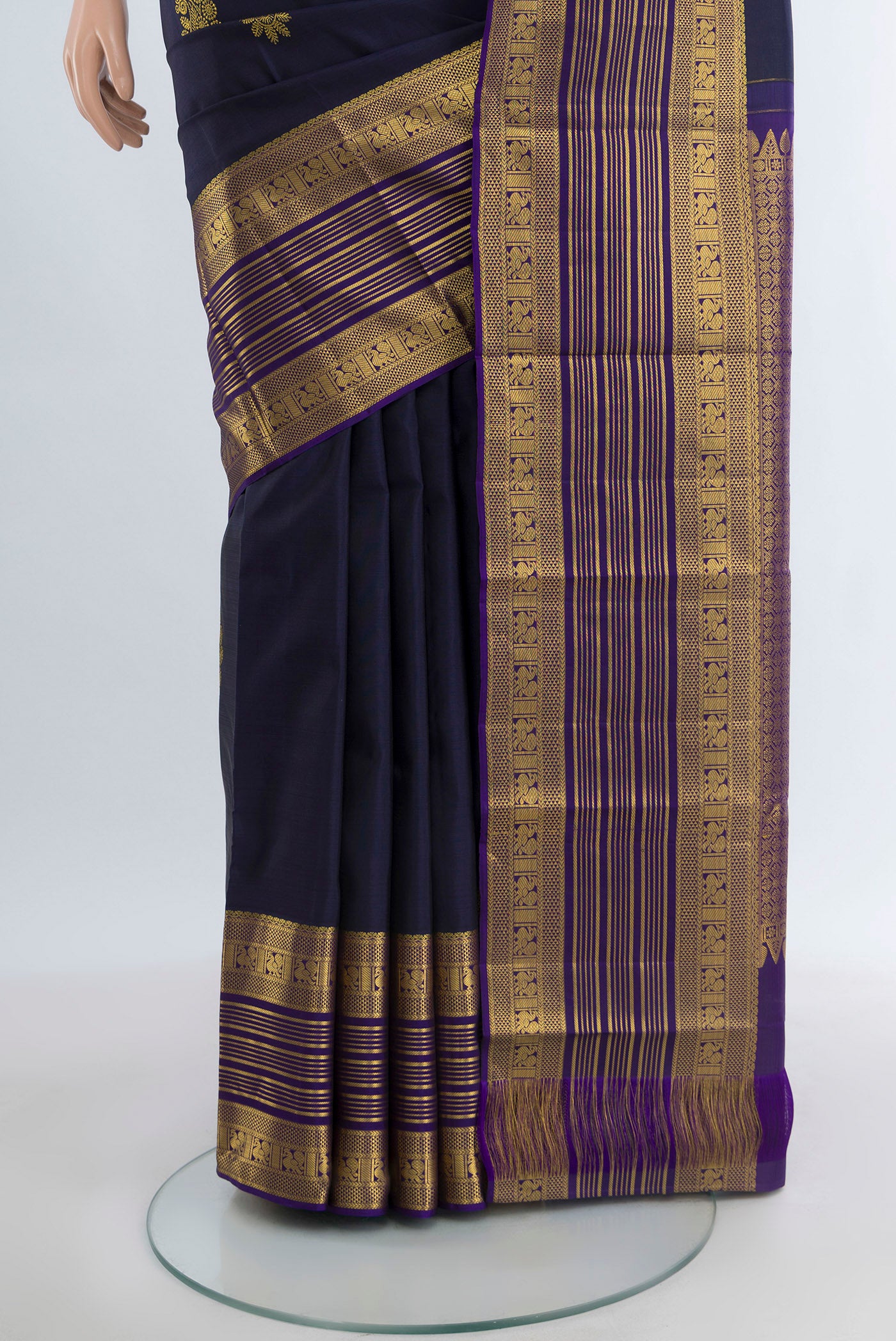 Pleats and pallu of Navy Blue Kanchipuram Silk Saree with Zari Butta on the body and Zari Border. 