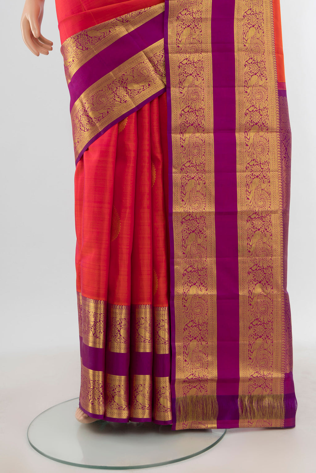 Pleats and pallu of Brick Orange Kanchipuram Silk Saree with Zari Butta on the body and Zari Border. 