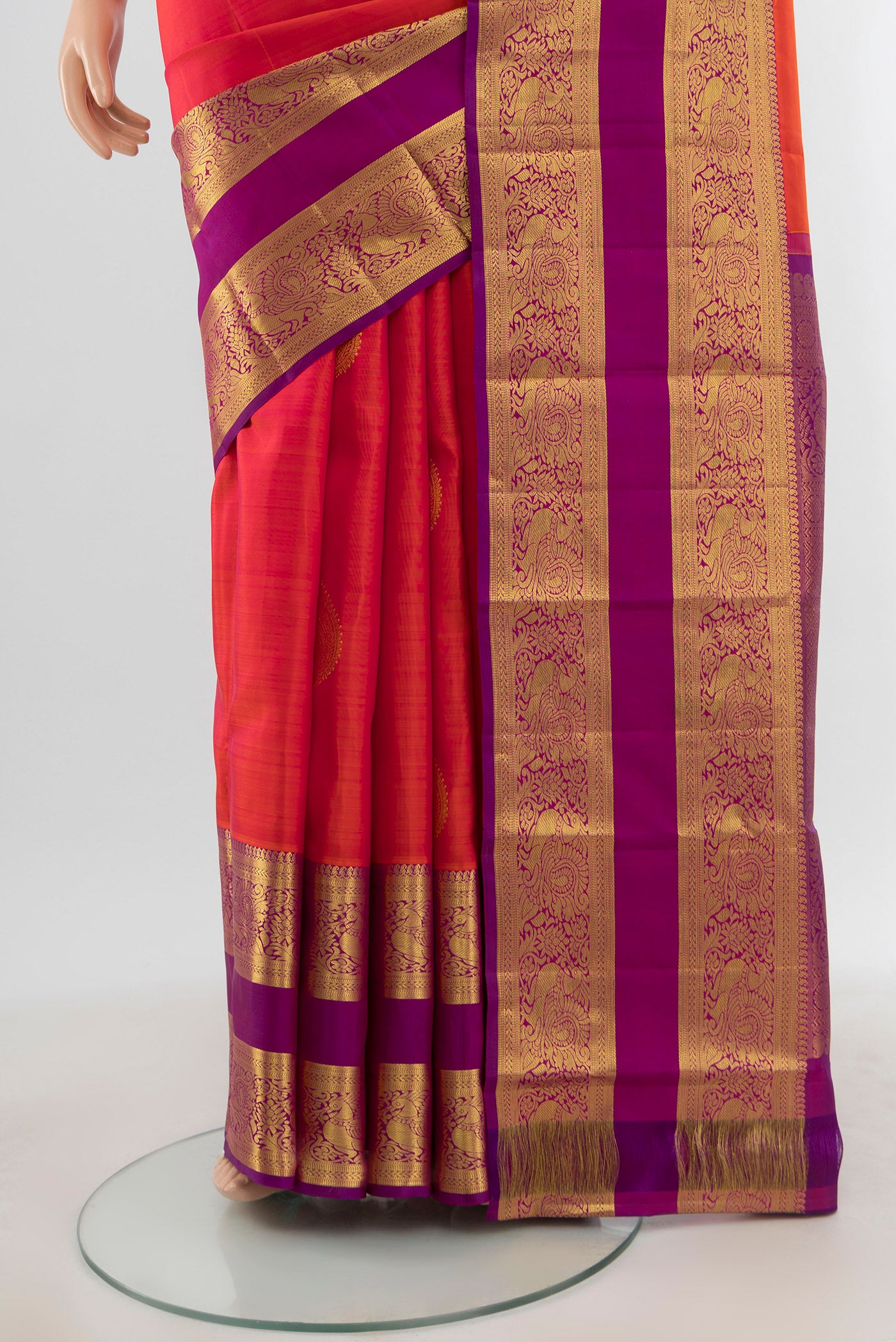 Pleats and pallu of Brick Orange Kanchipuram Silk Saree with Zari Butta on the body and Zari Border. 