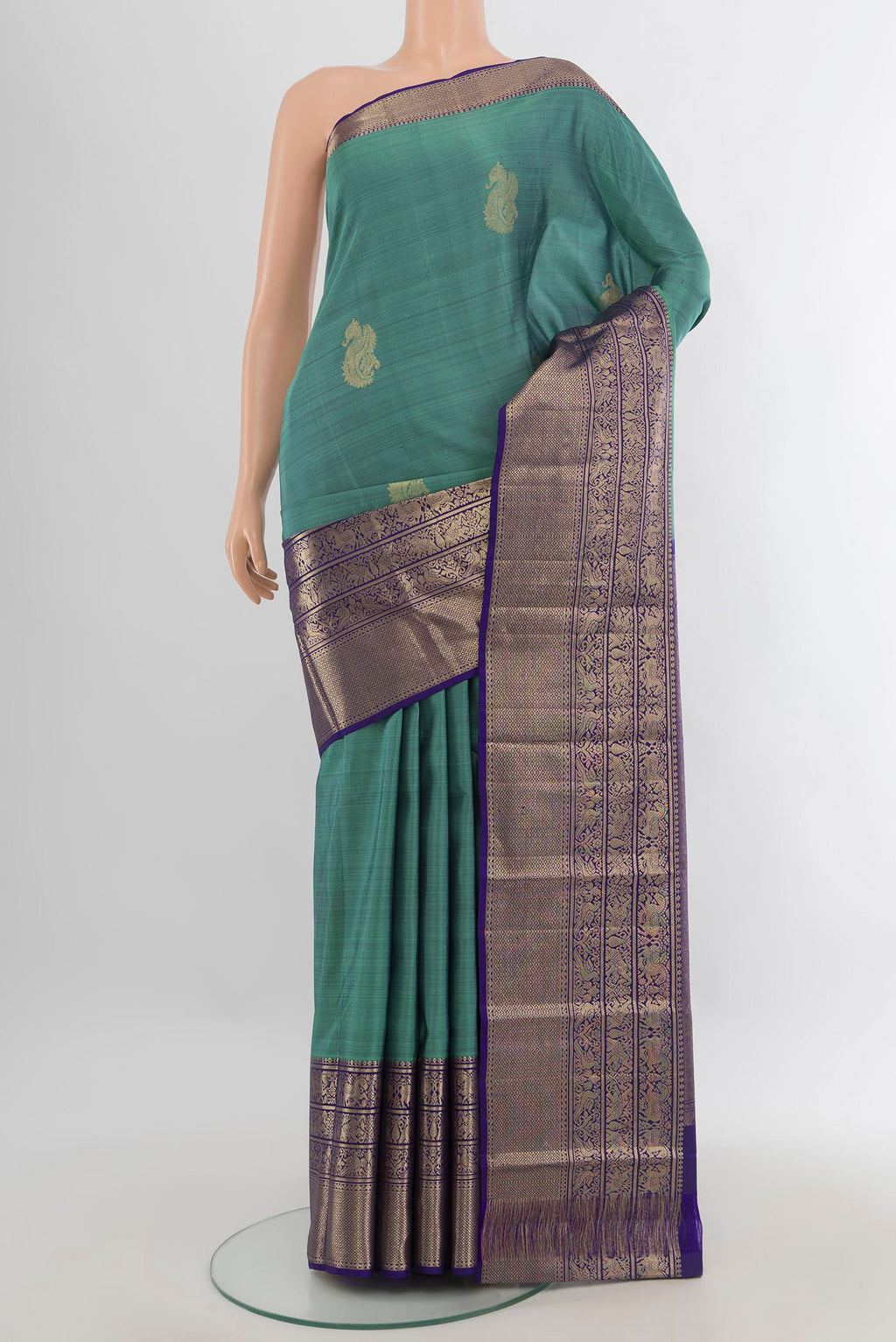 Pure Silk Sea Green Kanchipuram Saree with Zari Butta on the body and Zari Border.  displayed on a mannequin