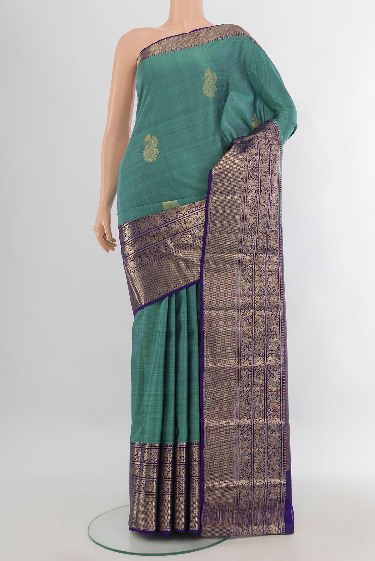 Pure Silk Sea Green Kanchipuram Saree with Zari Butta on the body and Zari Border.  displayed on a mannequin