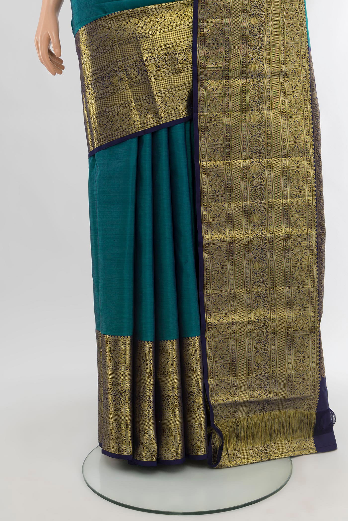 Pleats and pallu of Peacock Blue Kanchipuram Silk Saree with Zari Butta on the body and Zari Border. 
