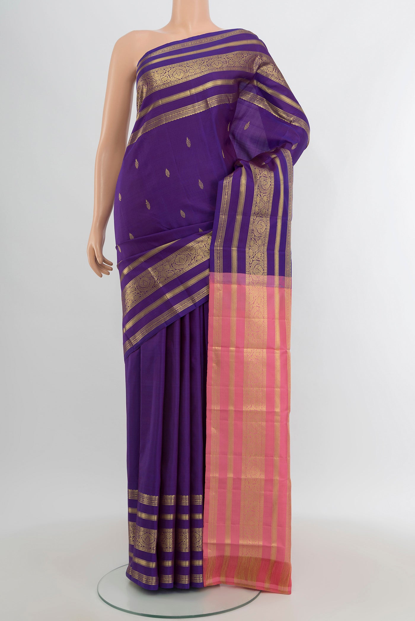 Violet Kanchipuram Silk Saree with Zari Butta on the body and Zari Border.  displayed on a mannequin