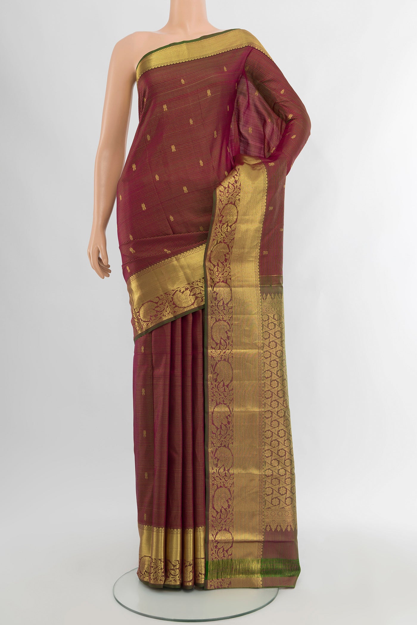 Maroon Kanchipuram Silk Saree with Zari Butta on the body and Zari Border.  displayed on a mannequin