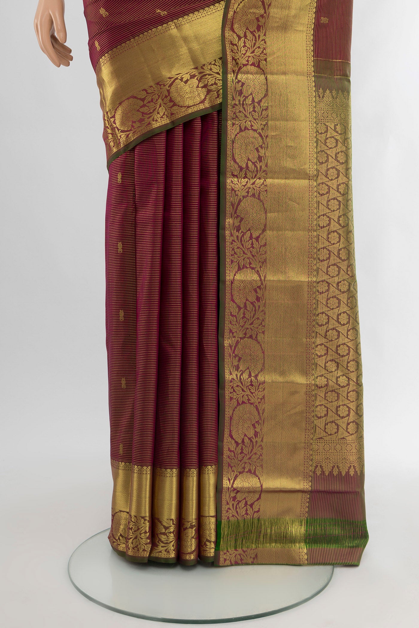 Pleats and pallu of Maroon Kanchipuram Silk Saree with Zari Butta on the body and Zari Border. 