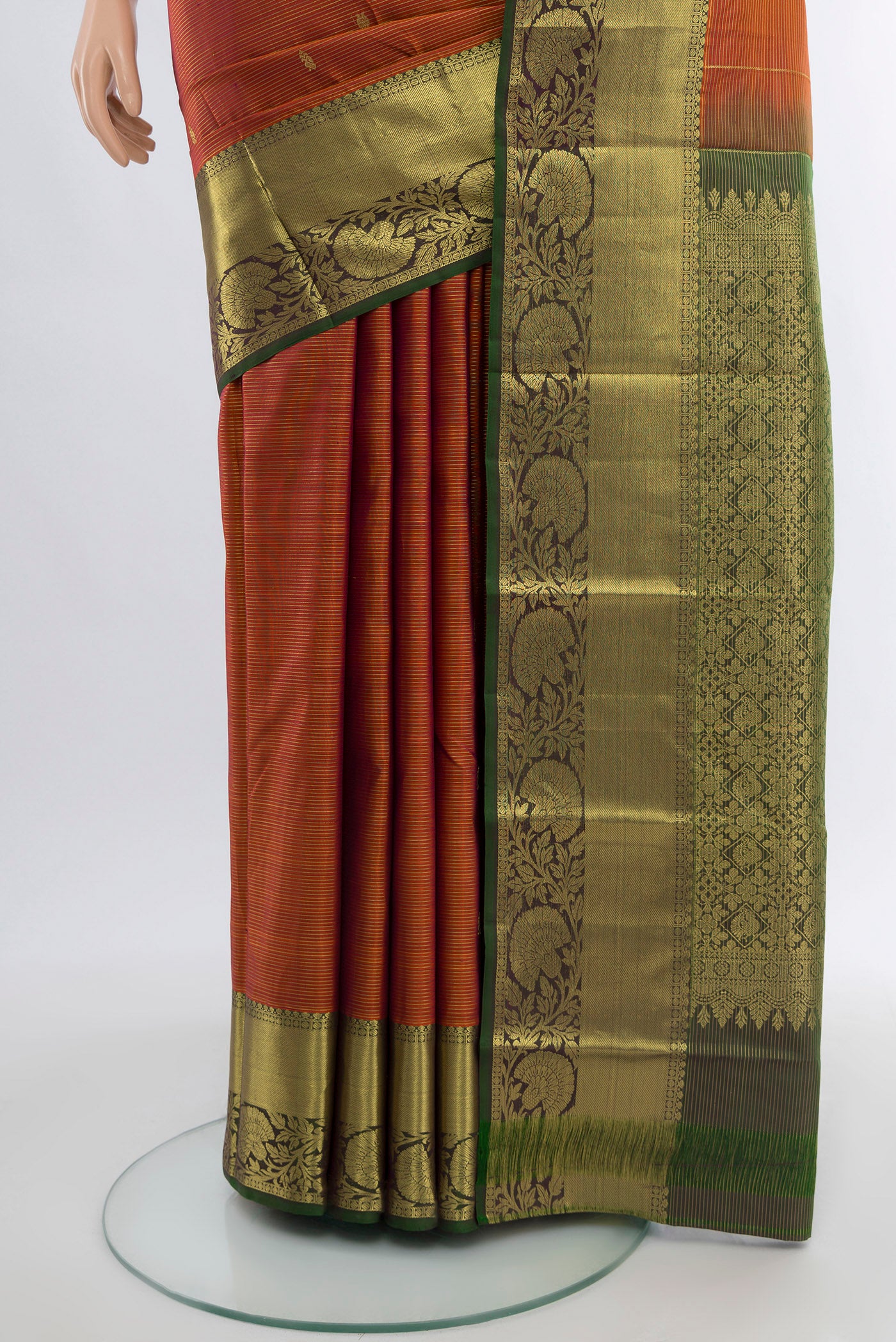Pleats and pallu of Pure Silk Pure Zari Rust Kanchipuram Saree with Zari Butta on the body and Silk Border. 