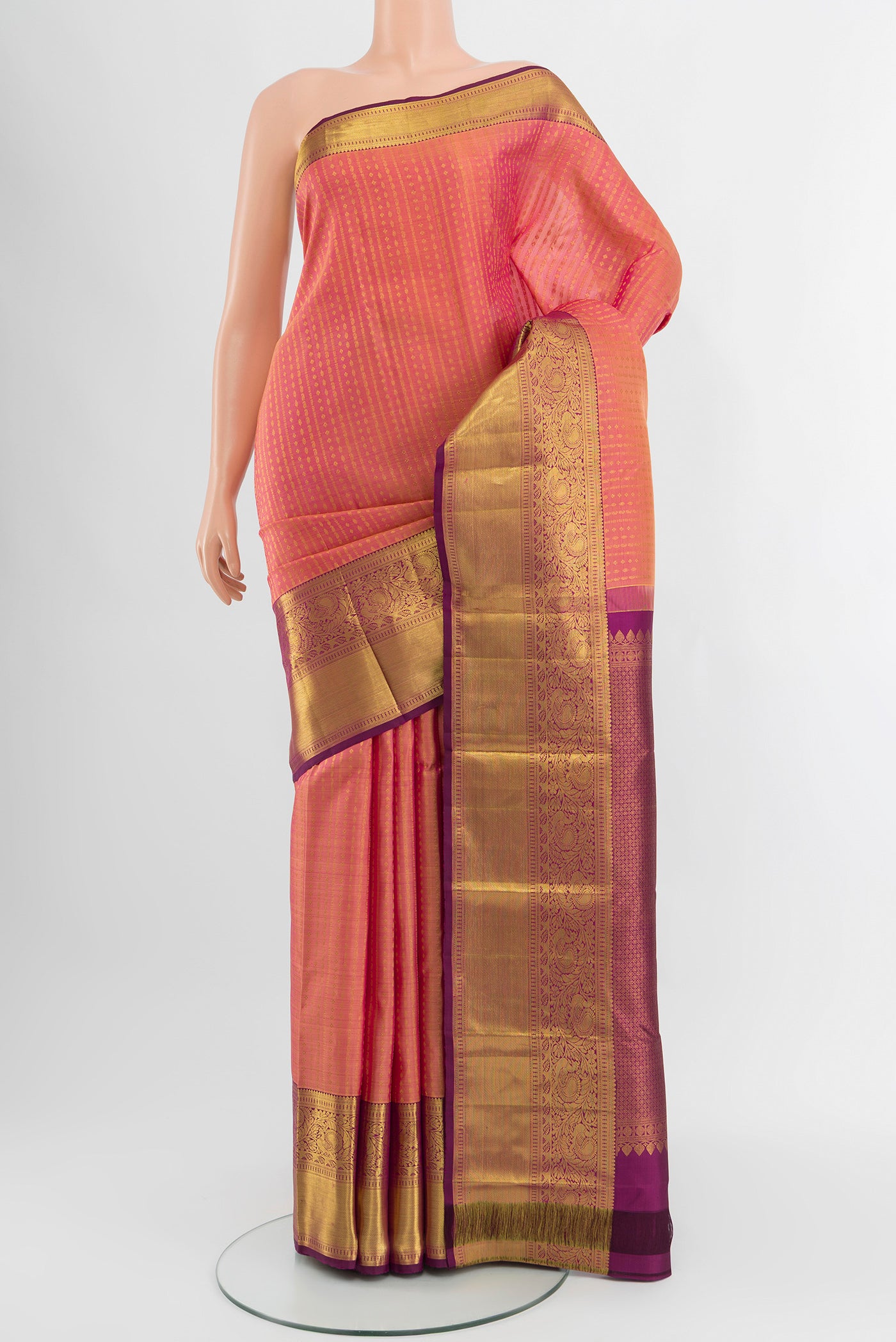 Coral Kanchipuram Silk Saree with Zari Butta on the body and Zari Border.  displayed on a mannequin