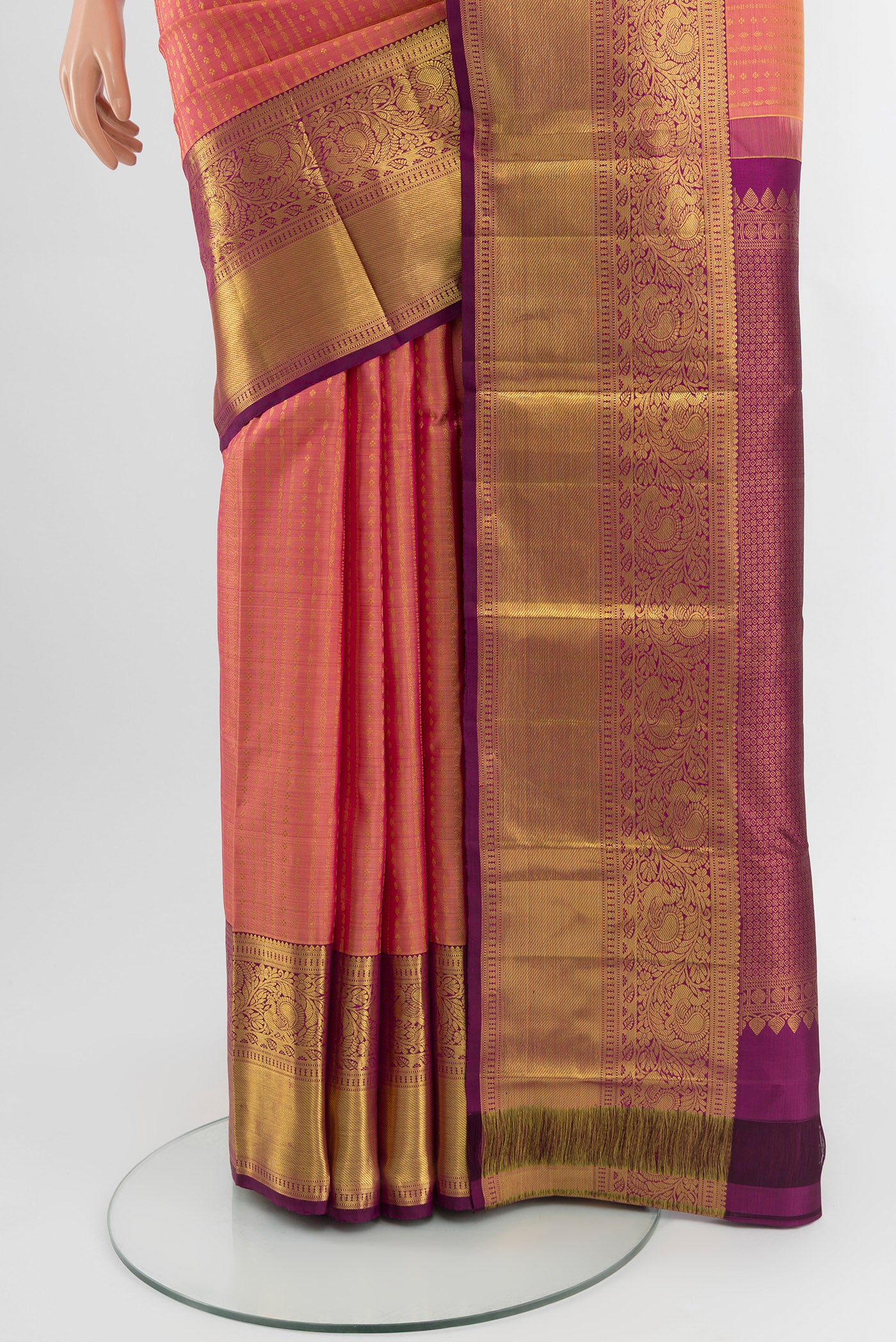 Pleats and pallu of Coral Kanchipuram Silk Saree with Zari Butta on the body and Zari Border. 