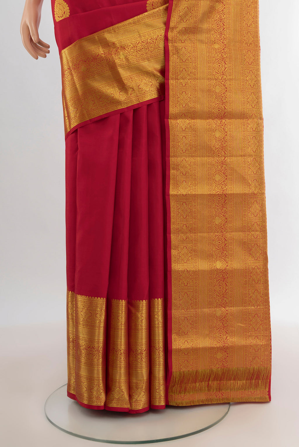 Pleats and pallu of Red Kanchipuram Silk Saree with Zari Butta on the body and Zari Border. 