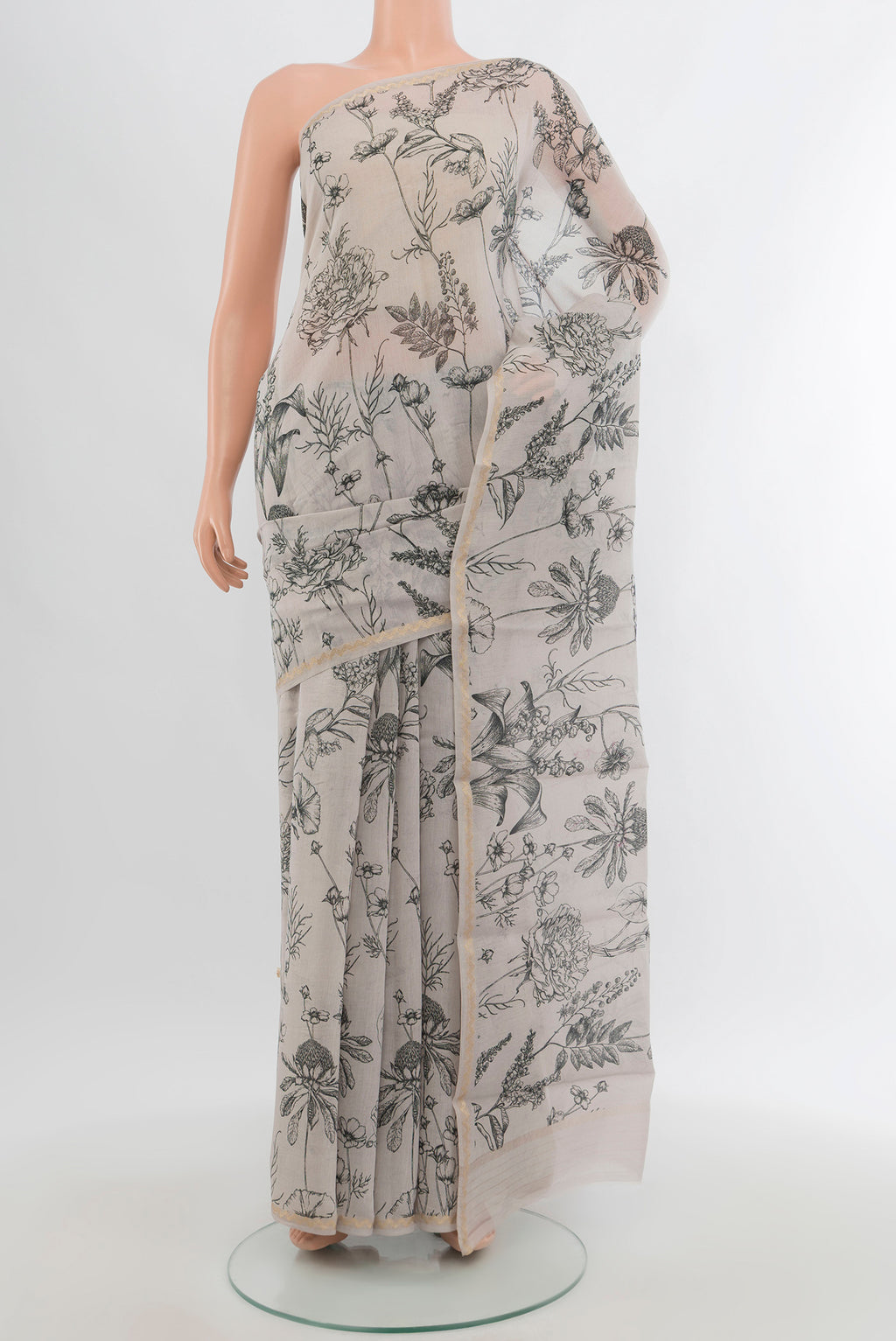 Grey Maheshwari Silk Cotton Saree with Floral Print on the body and Thin Zari Line.  displayed on a mannequin