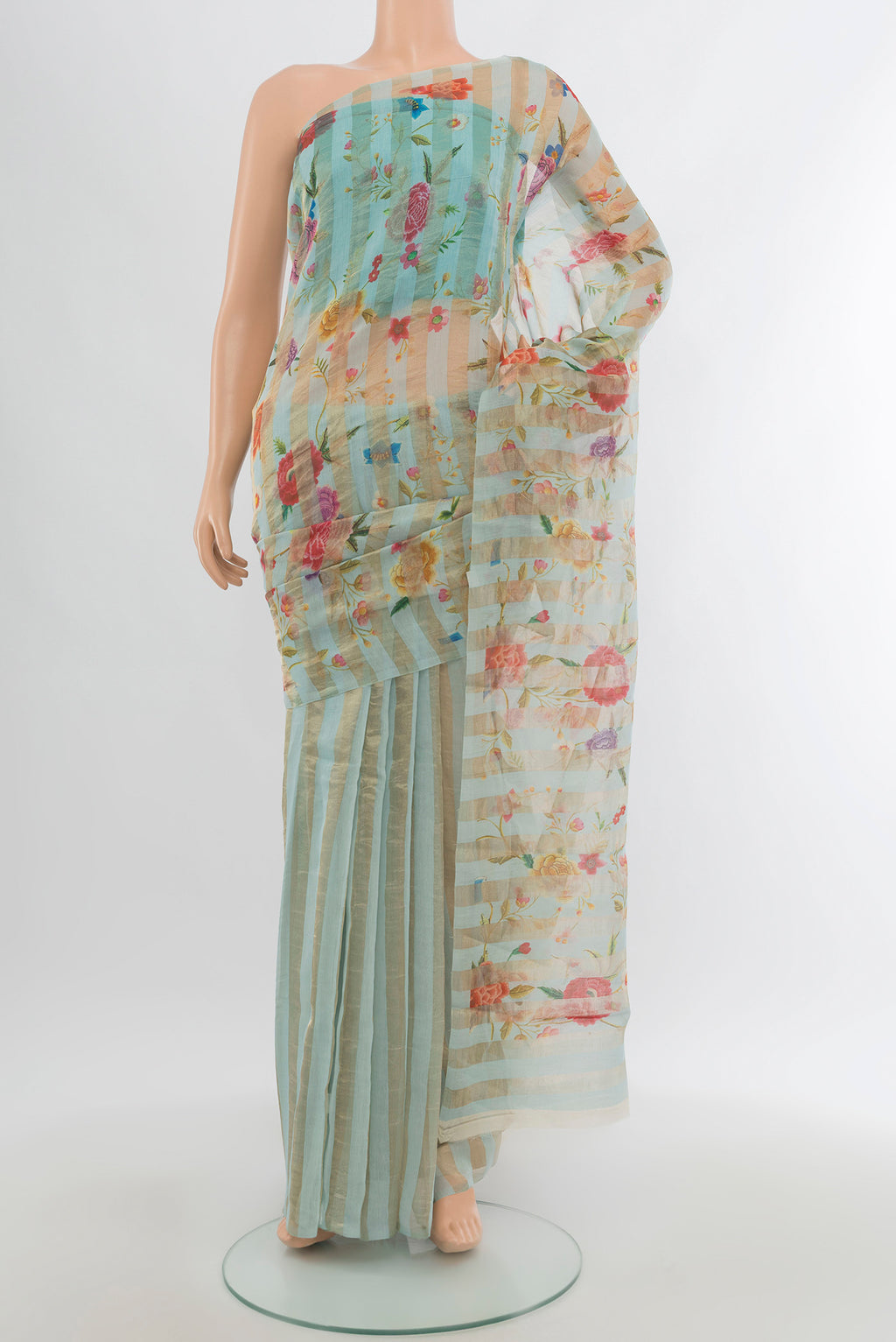 Light Blue Maheshwari Silk Cotton Saree with Floral Print on the body and Without Border.  displayed on a mannequin