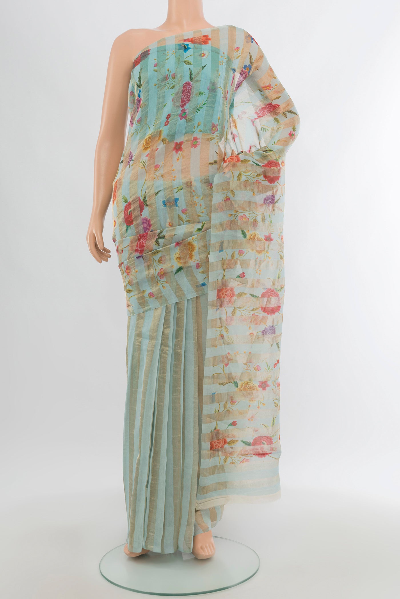 Light Blue Maheshwari Silk Cotton Saree with Floral Print on the body and Without Border.  displayed on a mannequin