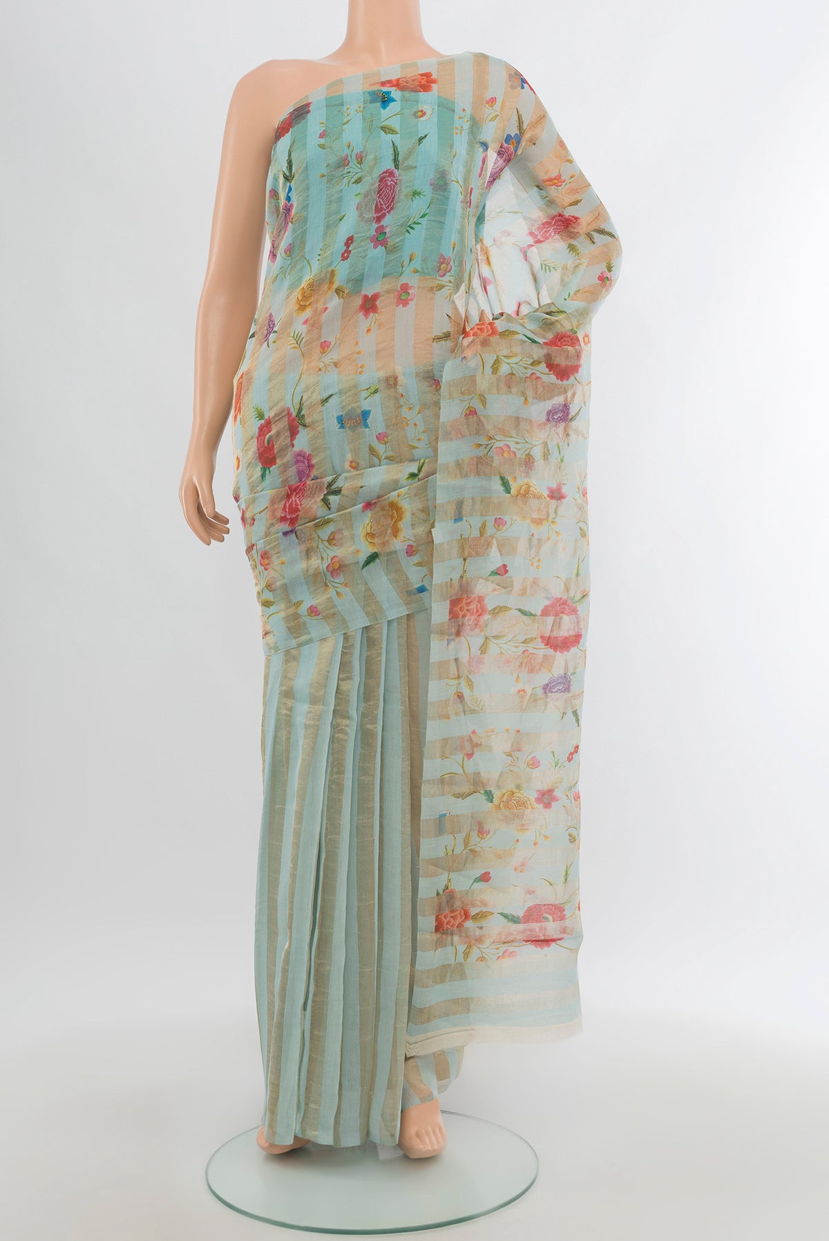 Light Blue Maheshwari Silk Cotton Saree with Floral Print on the body and Without Border.  displayed on a mannequin