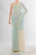 Cream Tussar Silk Saree with Floral Print on the body and Plain Border.  displayed on a mannequin
