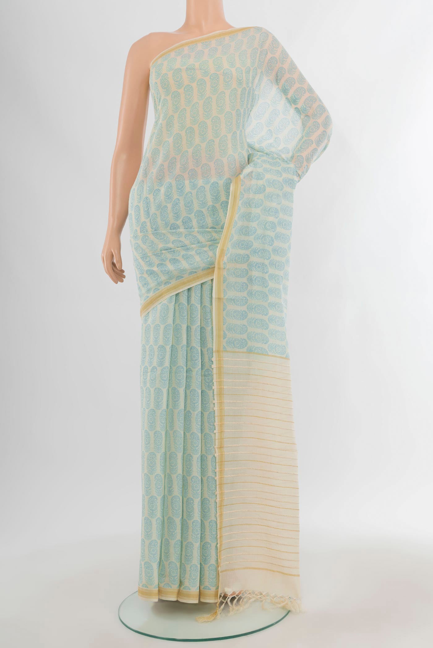Cream Tussar Silk Saree with Floral Print on the body and Plain Border.  displayed on a mannequin