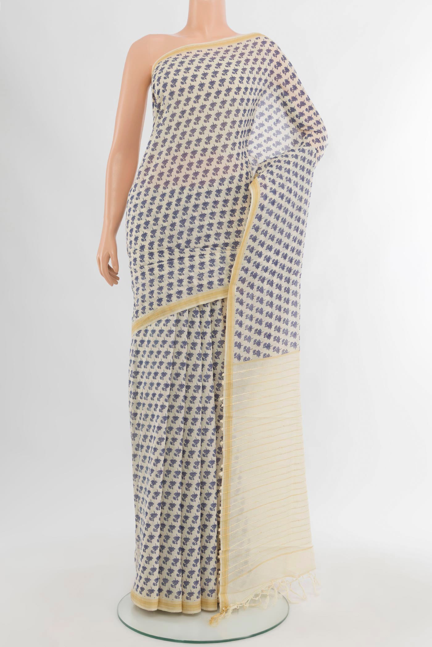 Cream Tussar Silk Saree with Floral Print on the body and Plain Border.  displayed on a mannequin