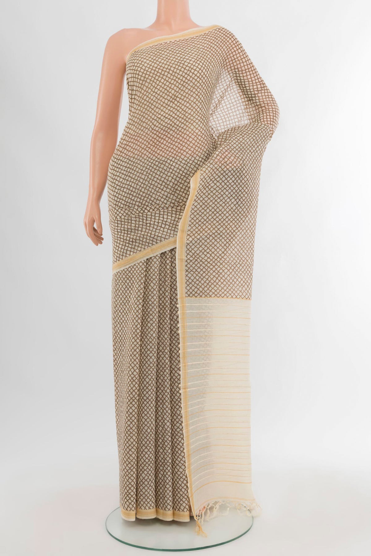 Cream Tussar Silk Saree with Floral Print on the body and Plain Border.  displayed on a mannequin