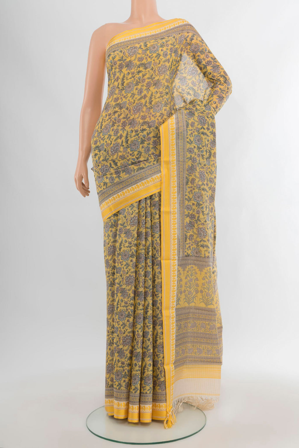 Yellow Tussar Silk Saree with Floral Print on the body and Thread Border.  displayed on a mannequin
