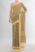 Yellow Tussar Silk Saree with Floral Print on the body and Thread Border.  displayed on a mannequin