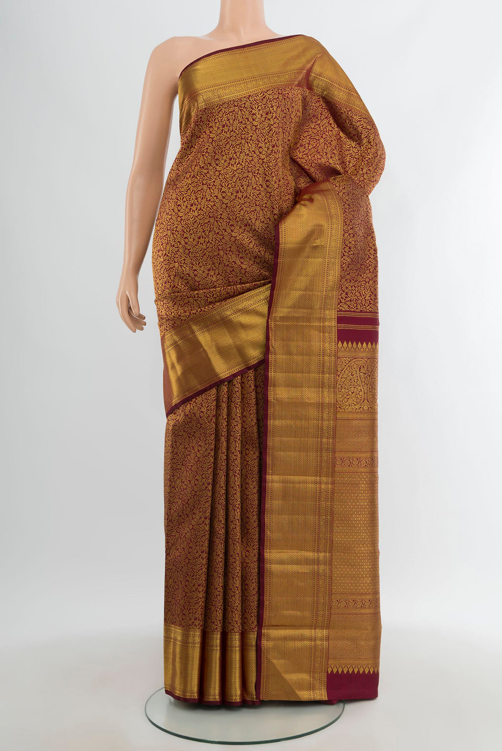 Maroon Kanchipuram Silk Saree with Zari Brocade on the body and Zari Border.  displayed on a mannequin