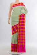 Pista Green Banarasi Silk Saree with Zari Butta on the body and Fancy Border.  displayed on a mannequin