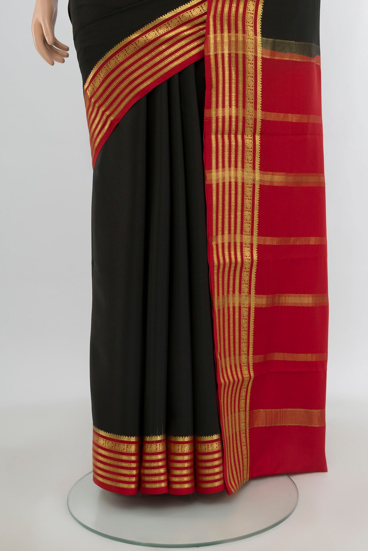 Pleats and pallu of Black Mysore Crepe Saree with Plain Body and Zari Border. 