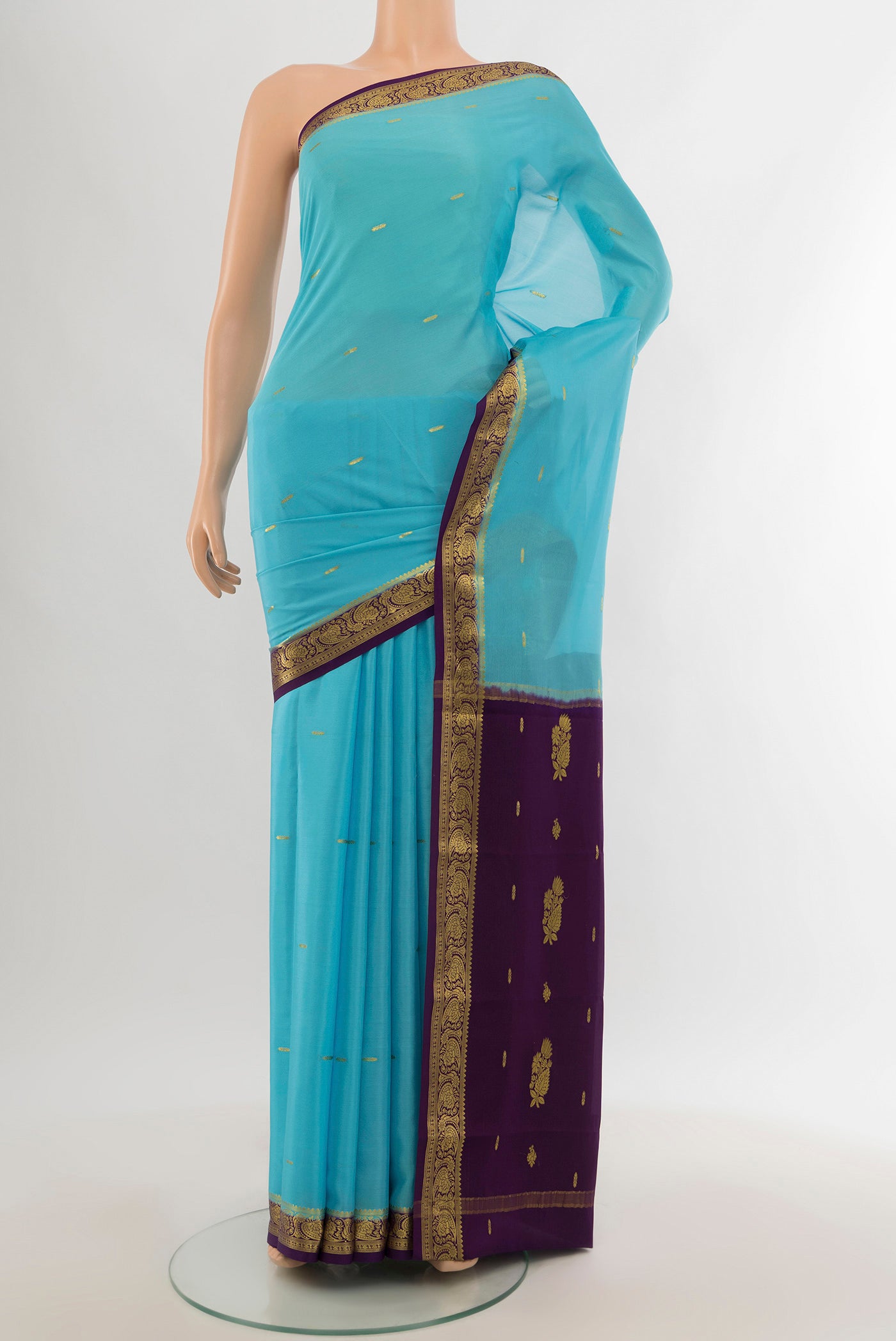 Sky Blue Mysore Crepe Saree with Zari Butta on the body and Silk Border.  displayed on a mannequin