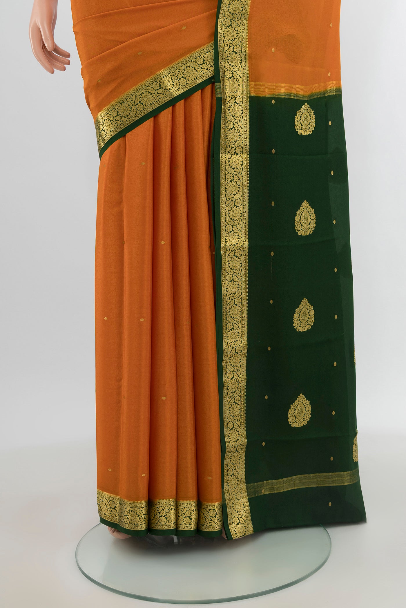 Pleats and pallu of Mustard Mysore Crepe Saree with Zari Butta on the body and Zari Border. 