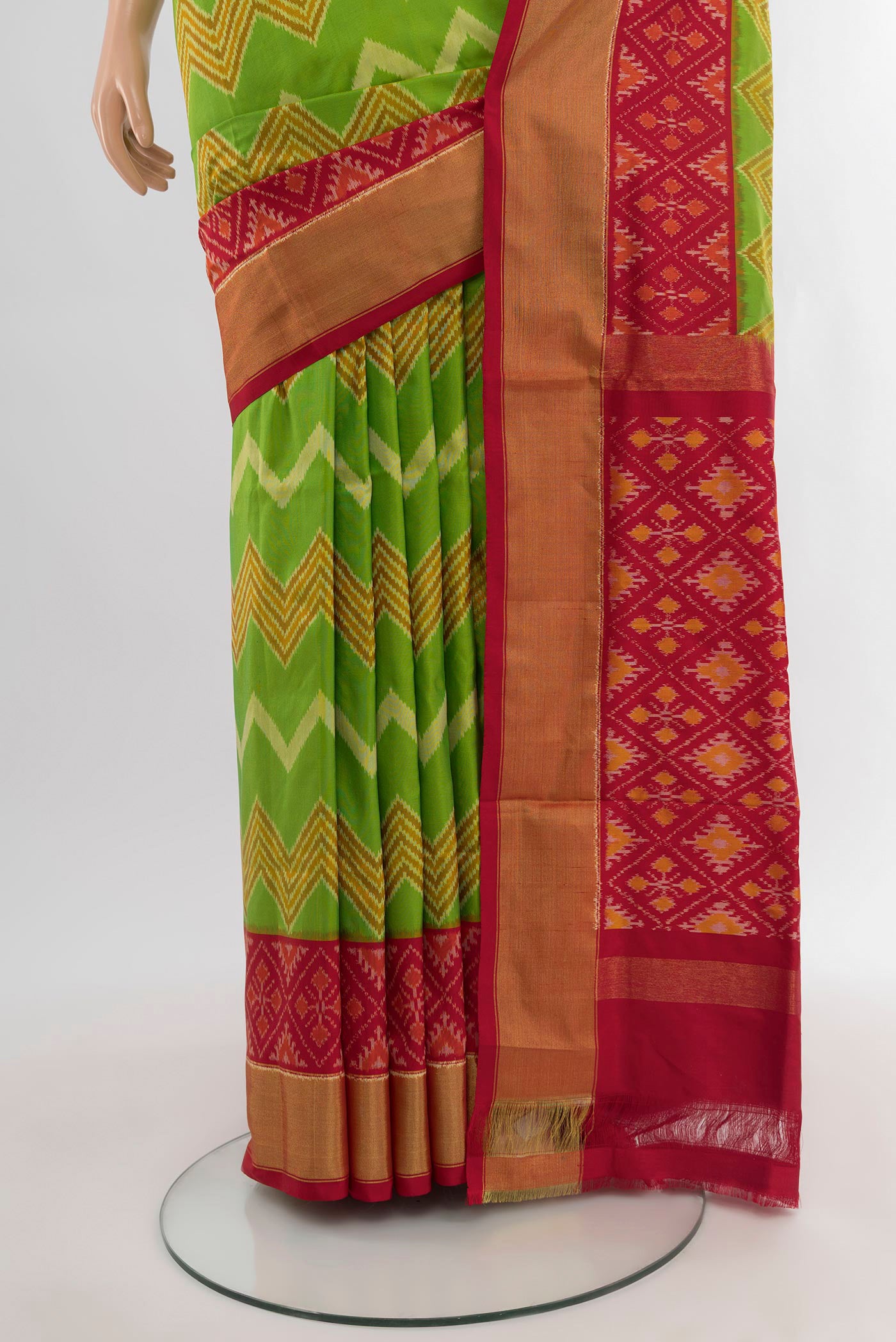 Pleats and pallu of Parrot Green Pochampally Silk Saree with Ikat design on the body and Ikat Border. 
