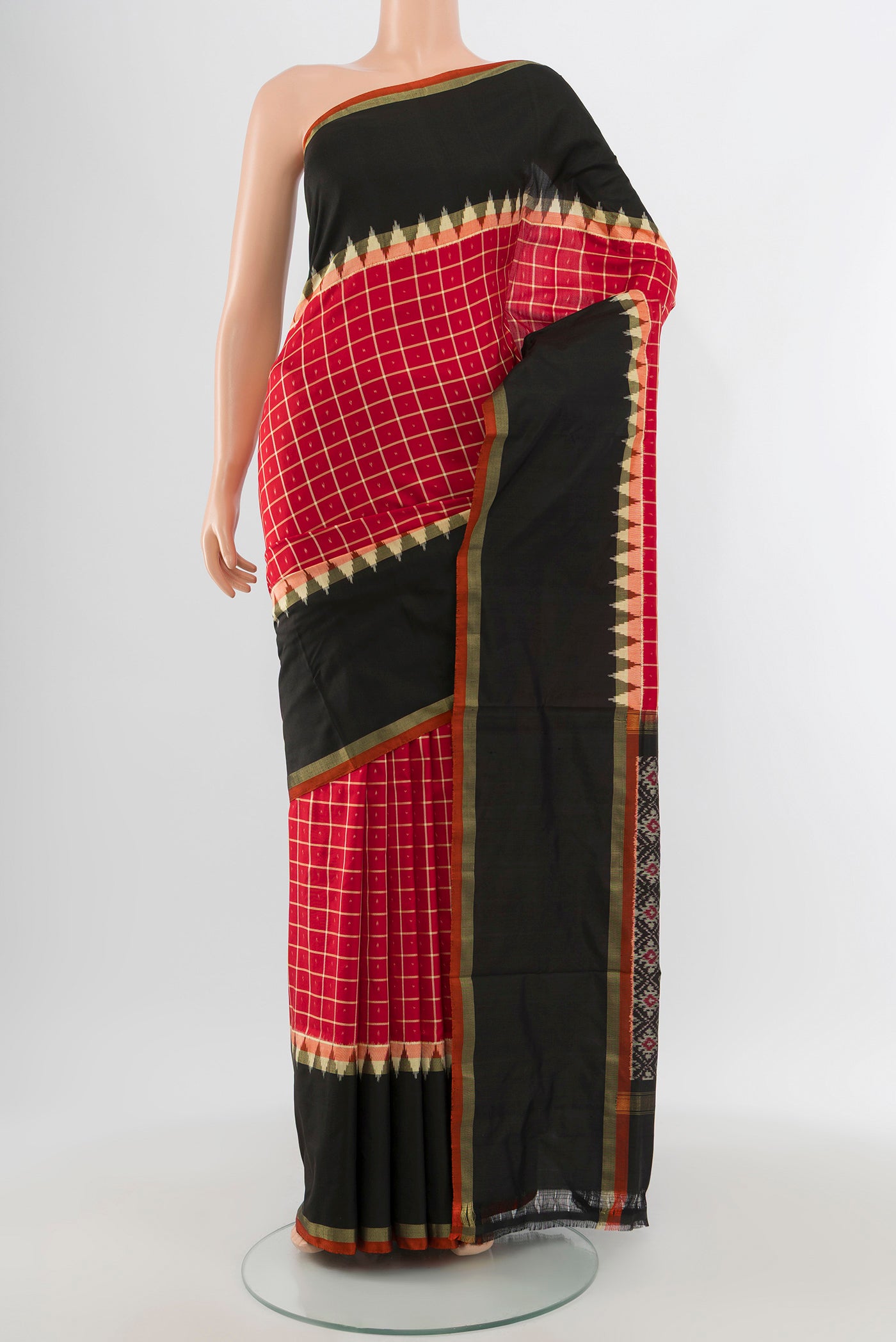Red Pochampally Silk Saree with Ikat design on the body and Ikat Border.  displayed on a mannequin