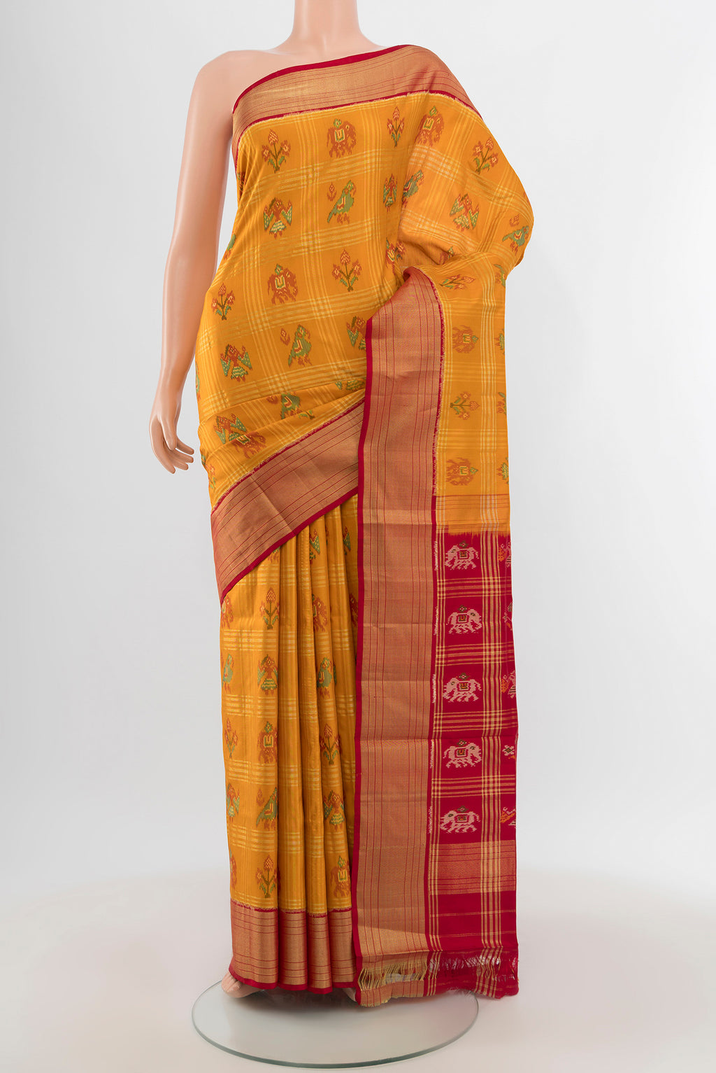 Mustard Pochampally Silk Saree with Ikat design on the body and Zari Border.  displayed on a mannequin